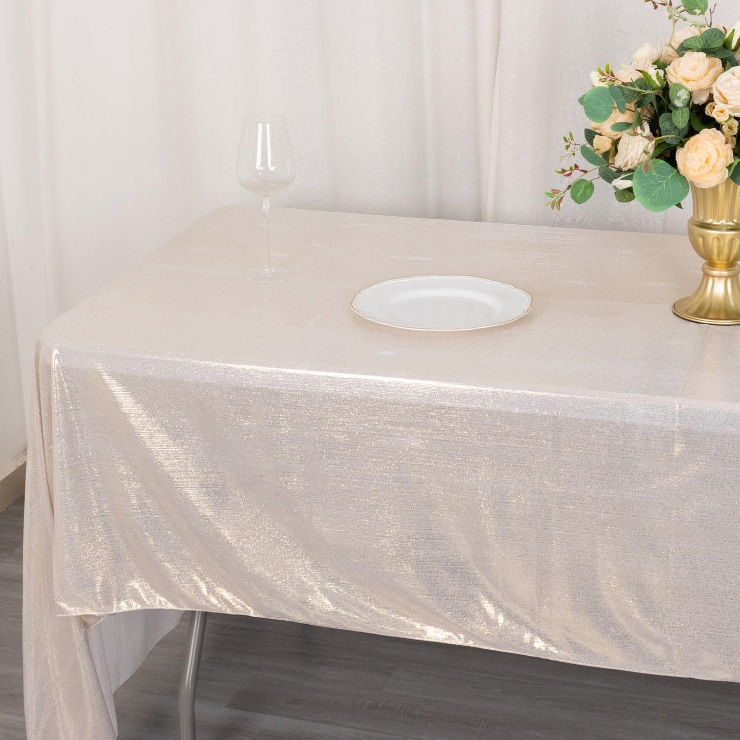Shiny beige rectangular tablecloth with shimmer sequin dots on a dining table.