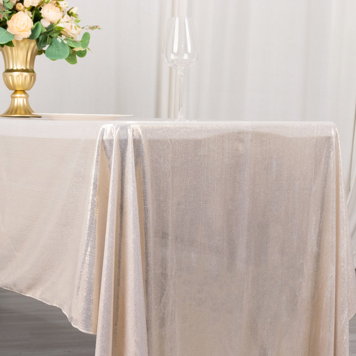 Shiny beige polyester tablecloth with shimmer sequin dots.