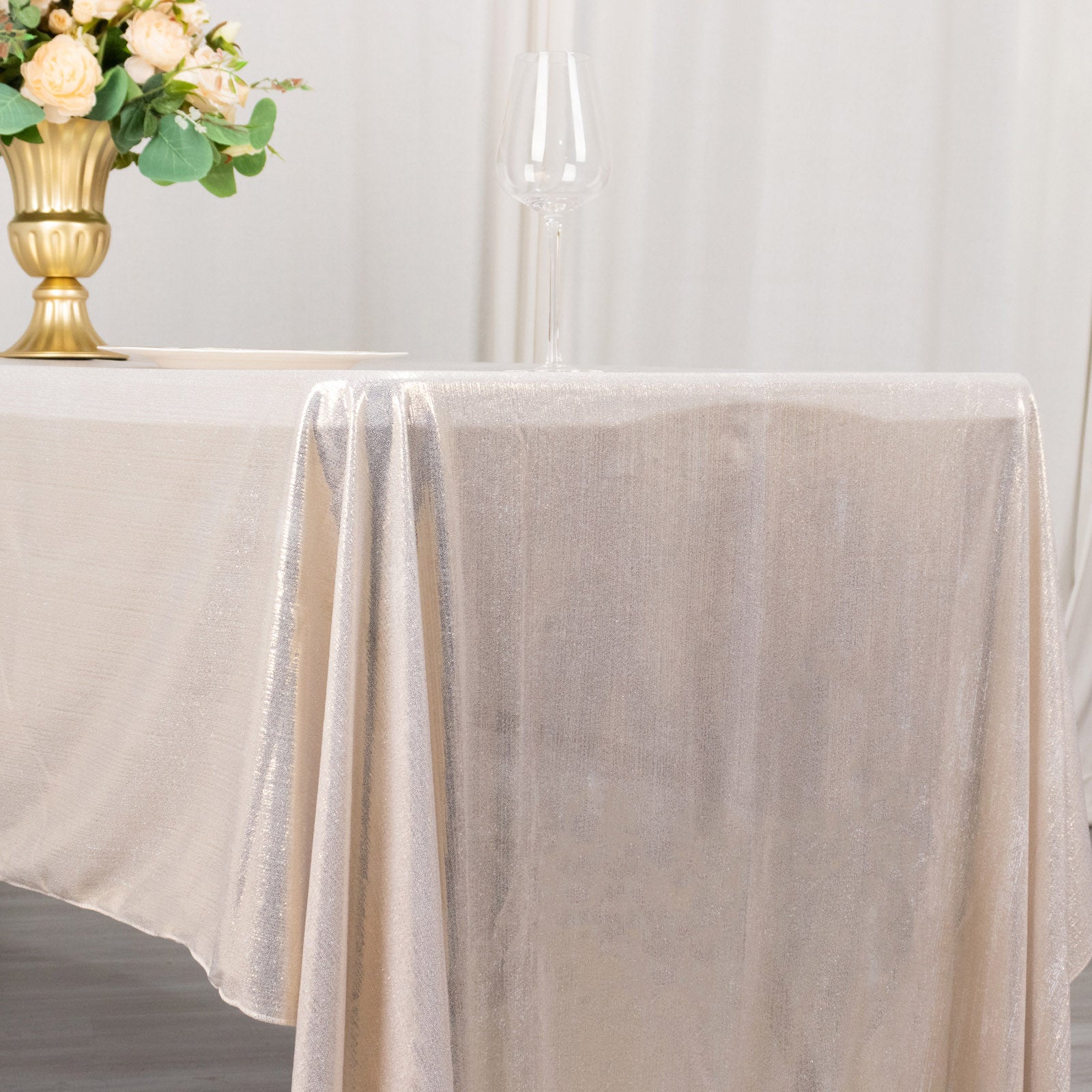 Shiny beige polyester tablecloth with shimmer sequin dots.
