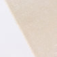 Shiny beige tablecloth with shimmer sequin dots on a white surface.