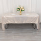 Shiny beige rectangular tablecloth with shimmer sequin dots on a dining table.