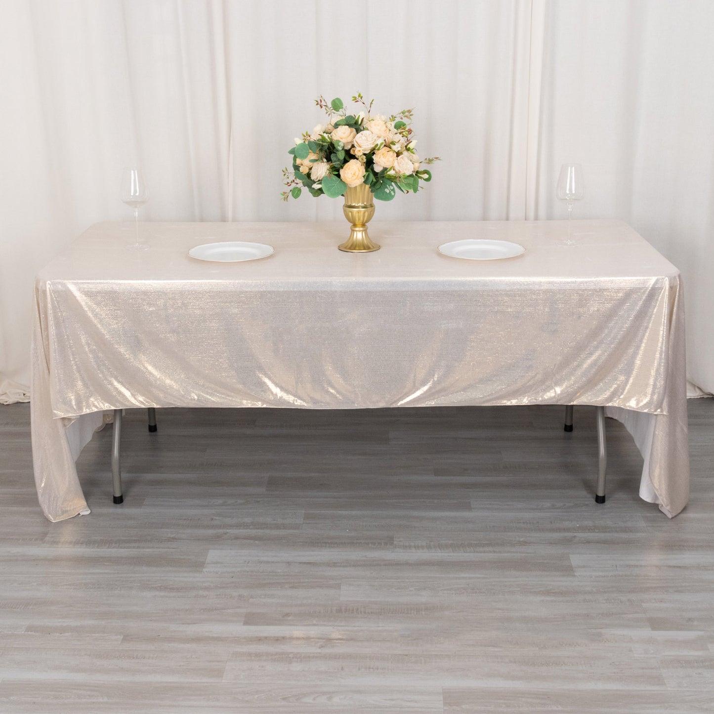 Shiny beige rectangular tablecloth with shimmer sequin dots on a dining table.