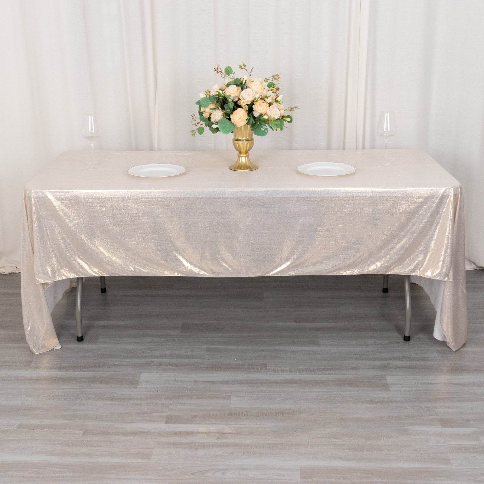 Shiny beige rectangular tablecloth with shimmer sequin dots on a dining table.