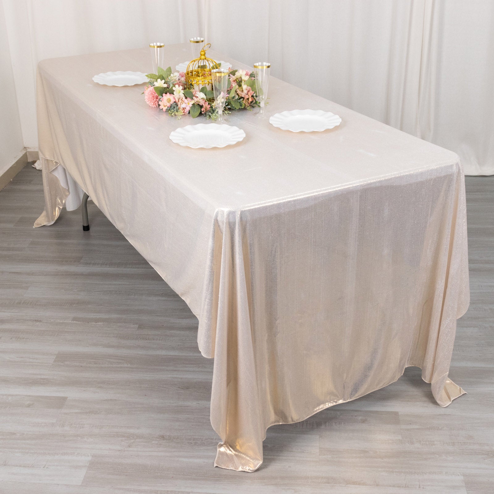 Shiny beige rectangular tablecloth with sequin dots on a dining table.