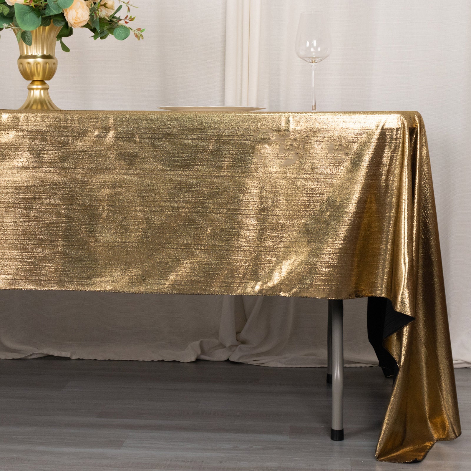 Shiny antique gold rectangular tablecloth with shimmer sequin dots.