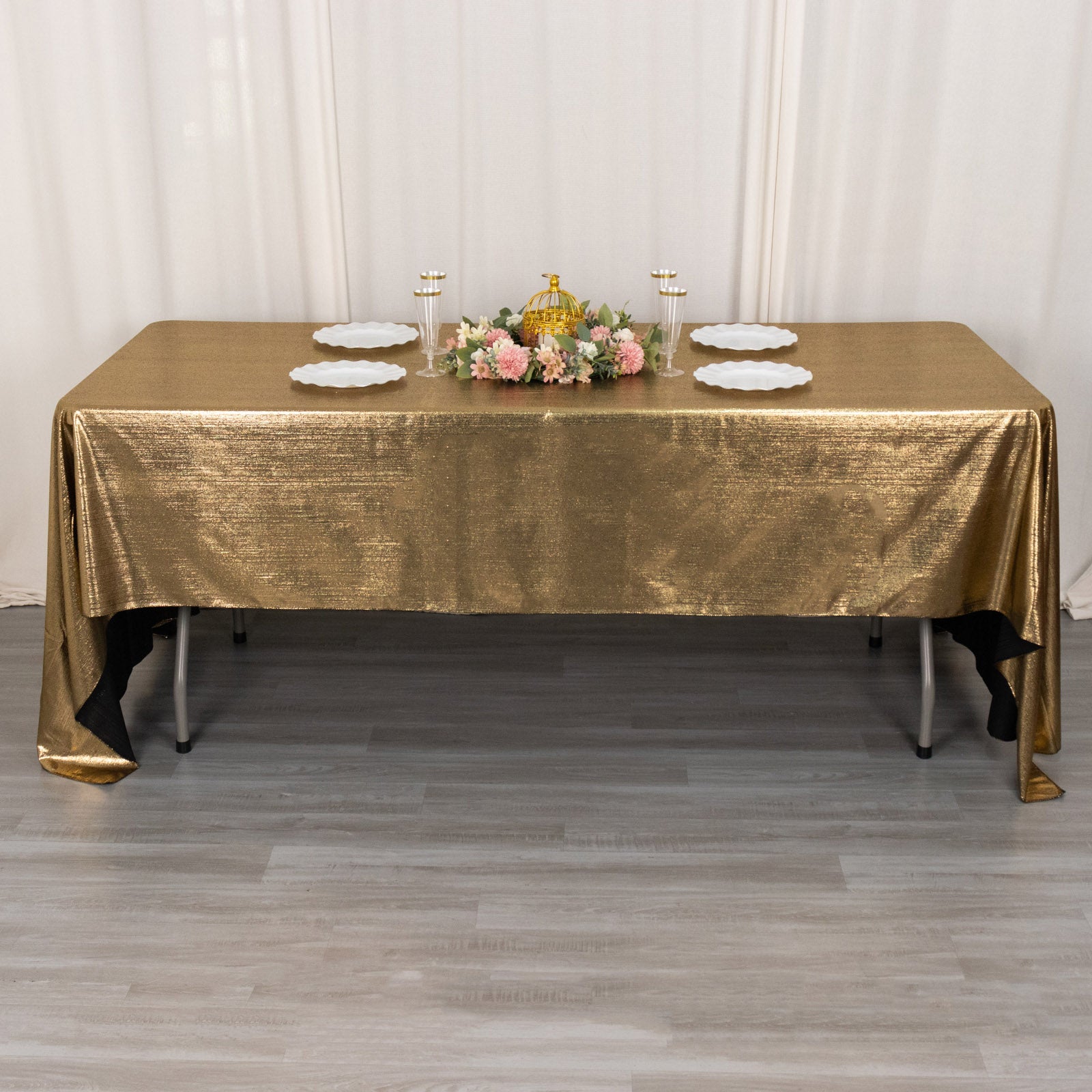 Shiny antique gold tablecloth with shimmer sequin dots on a rectangular table.