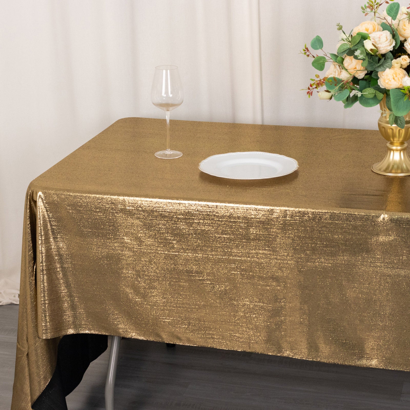 Shiny antique gold rectangular tablecloth with shimmer sequin dots.