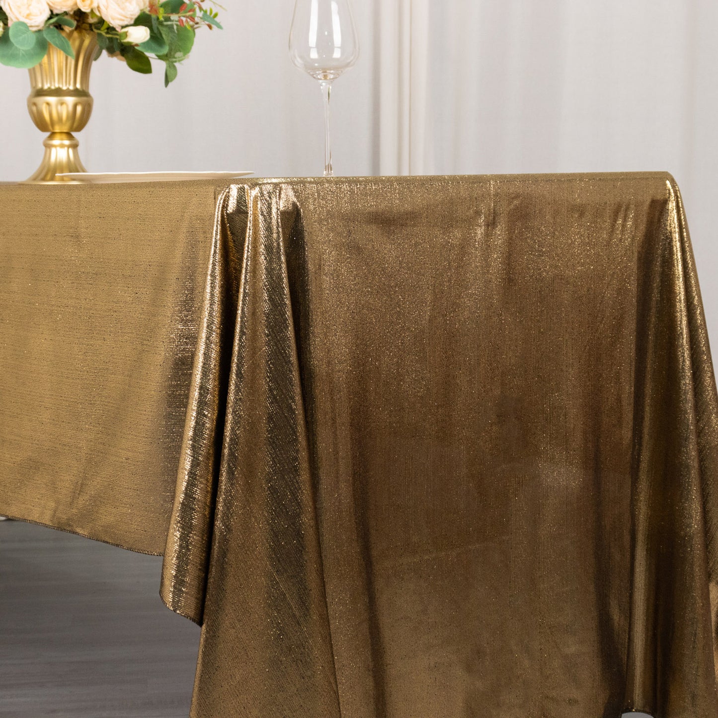 Shiny antique gold rectangular tablecloth with shimmer sequin dots.
