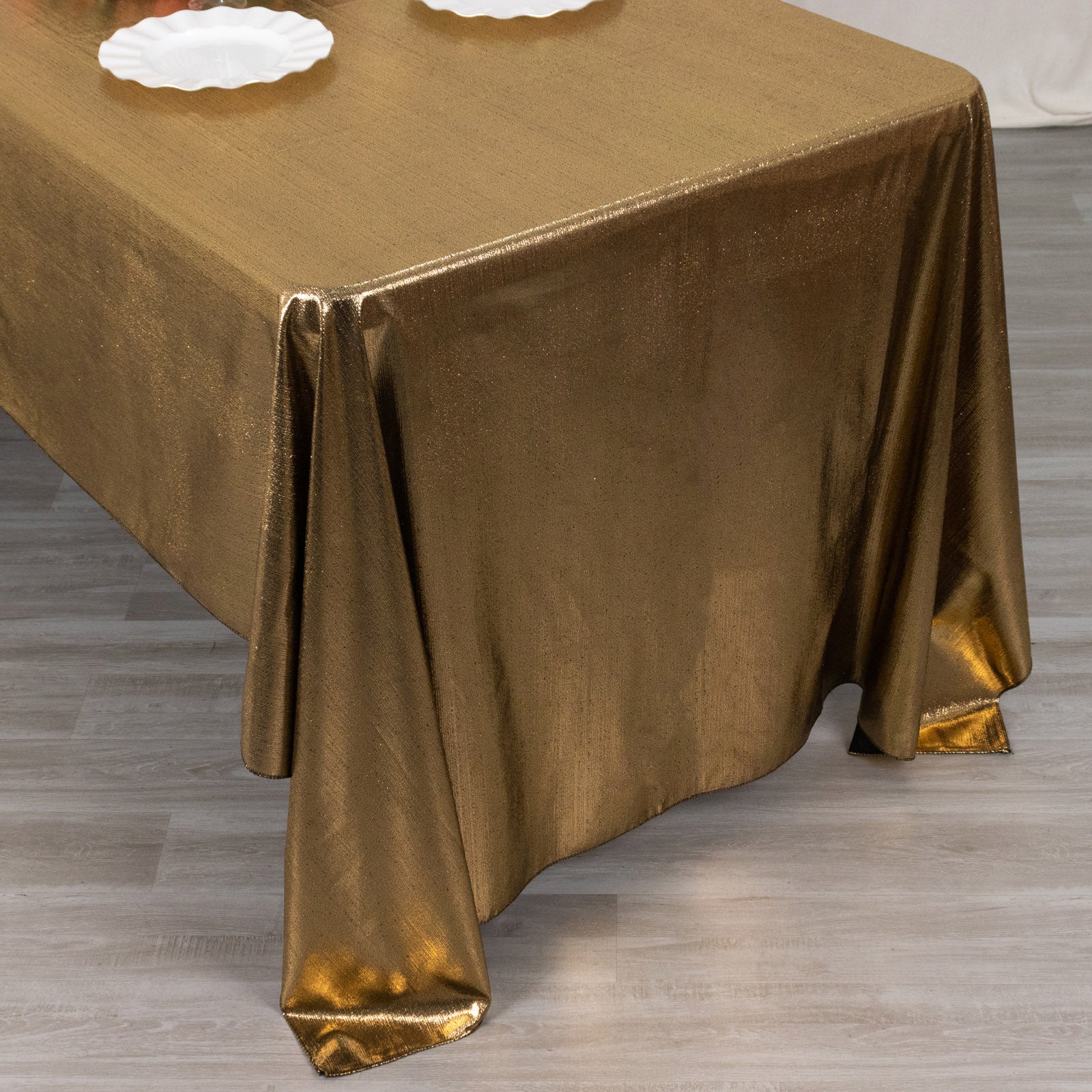Shiny antique gold rectangular tablecloth with shimmer sequin dots.