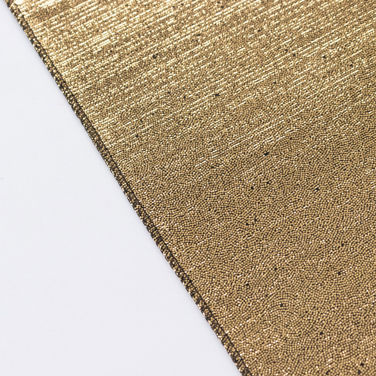 Shiny antique gold polyester tablecloth with sequin dots.