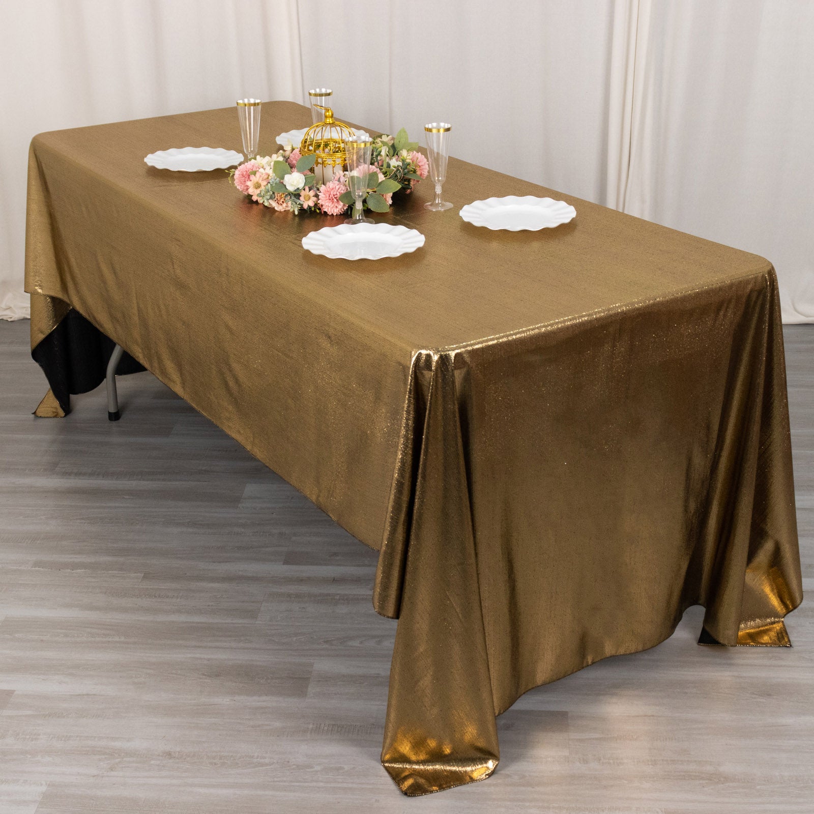 Shiny antique gold rectangular tablecloth with shimmer sequin dots.