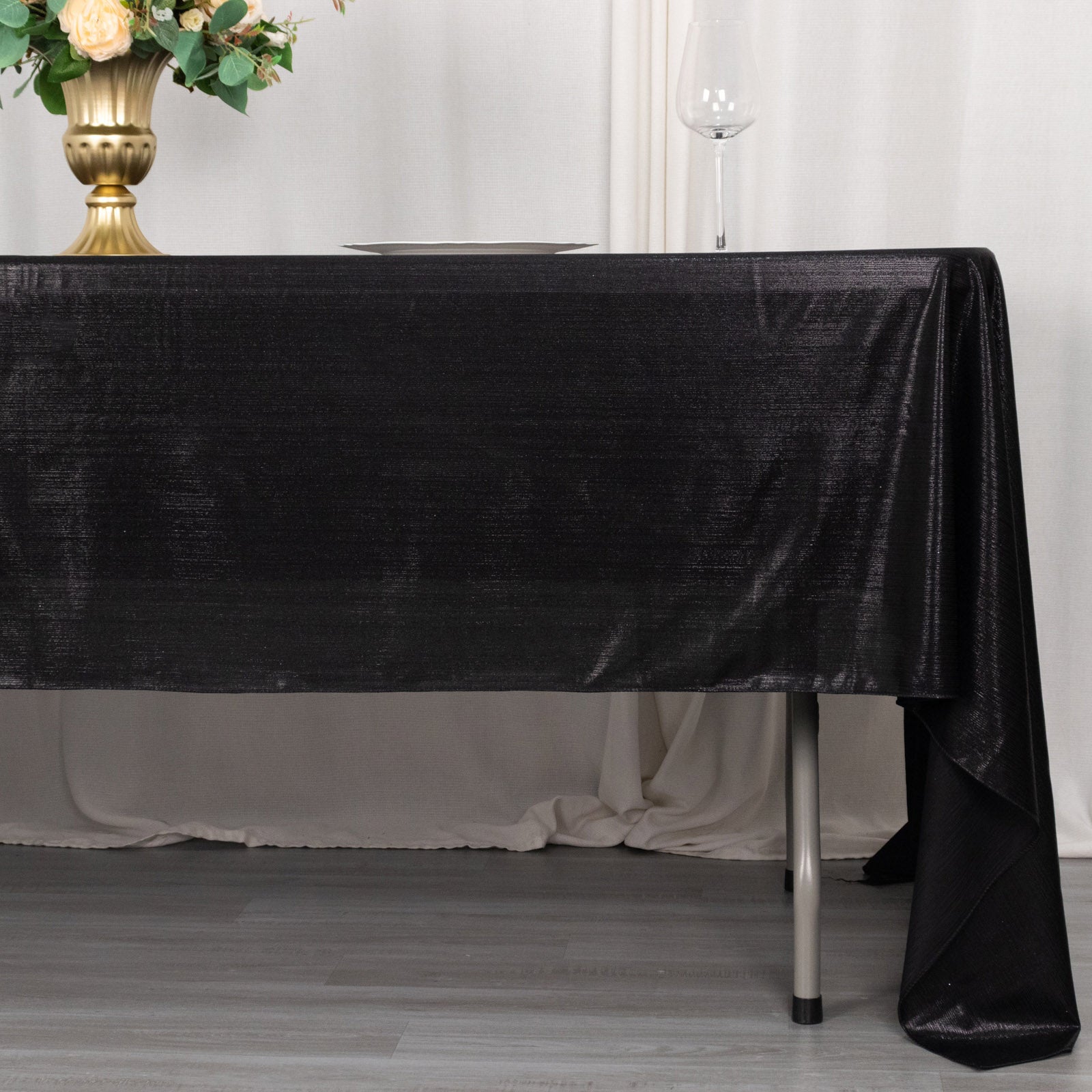 Shiny black polyester rectangular tablecloth with shimmer sequin dots.