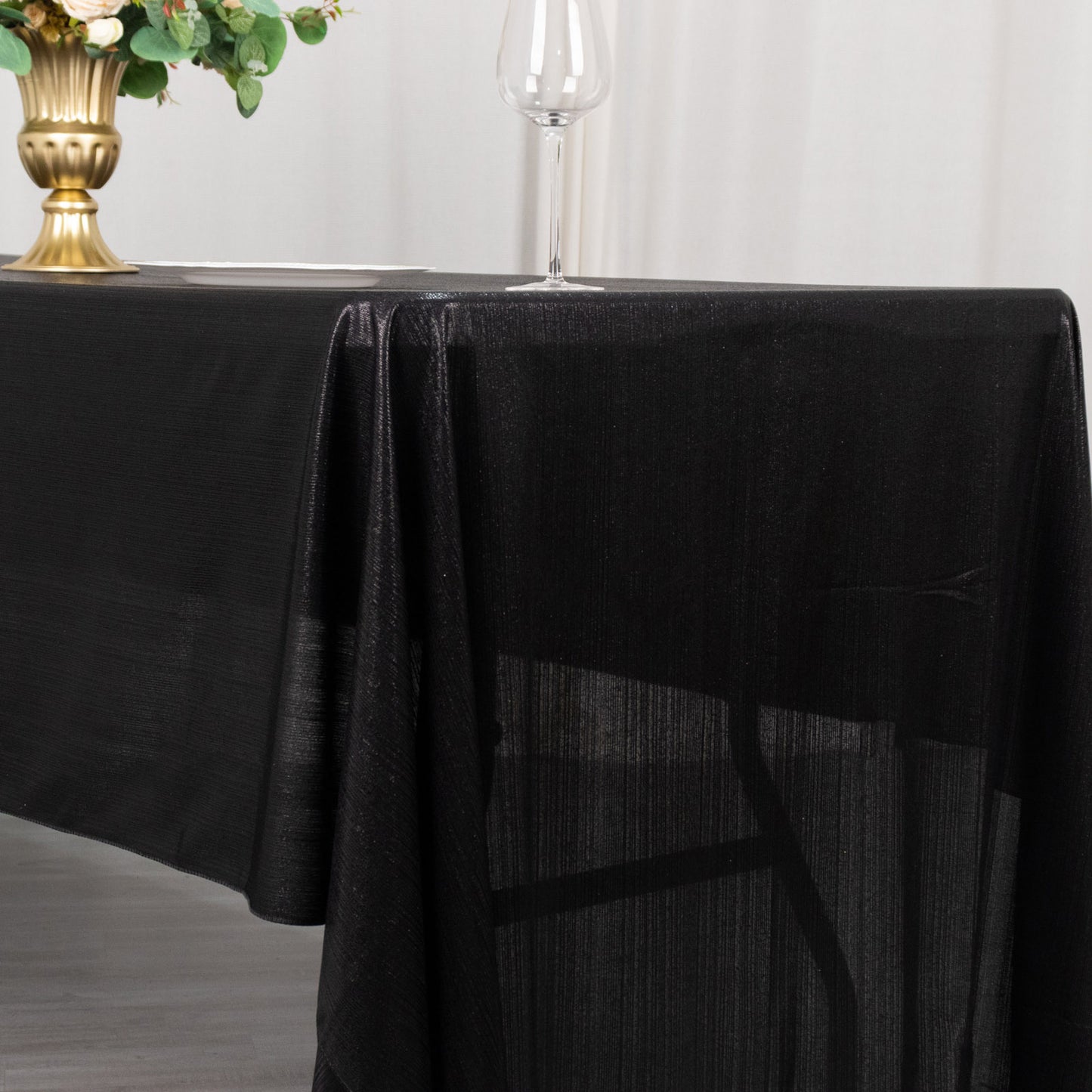 Shiny black rectangular tablecloth with shimmer sequin dots.