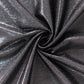 Shiny black polyester tablecloth with shimmer sequin dots.