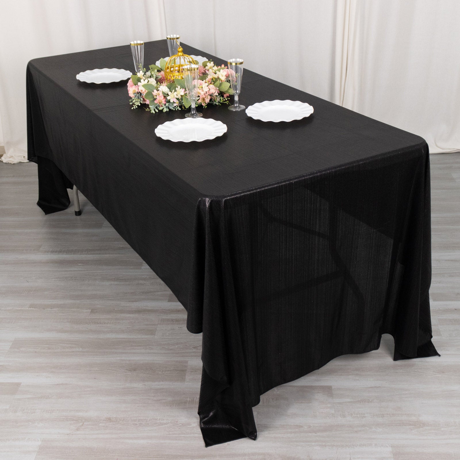 Shiny black polyester rectangular tablecloth with shimmer sequin dots.