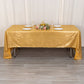 Shiny gold rectangular tablecloth with shimmer sequin dots on a table.