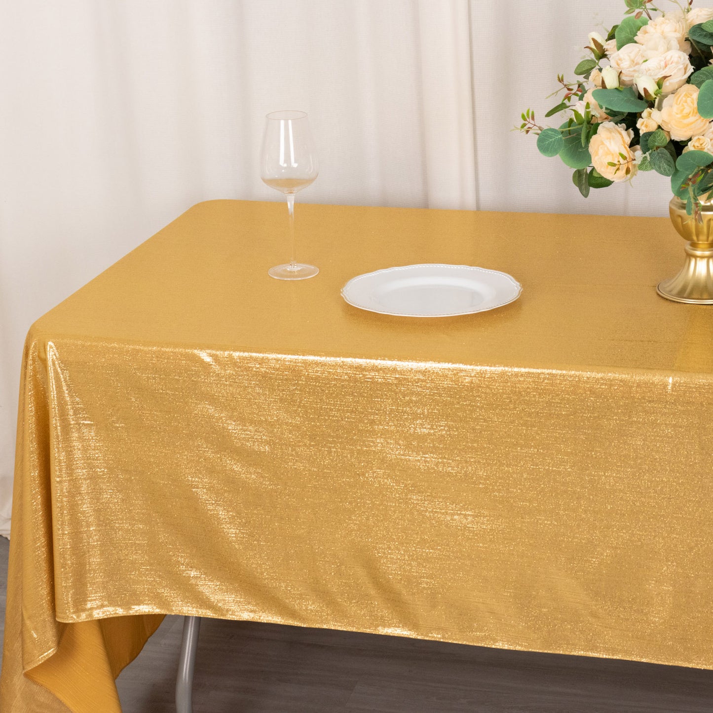 Shiny gold rectangular tablecloth with shimmer sequin dots.