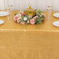 Shiny gold rectangular tablecloth with shimmer sequin dots on a decorated table.