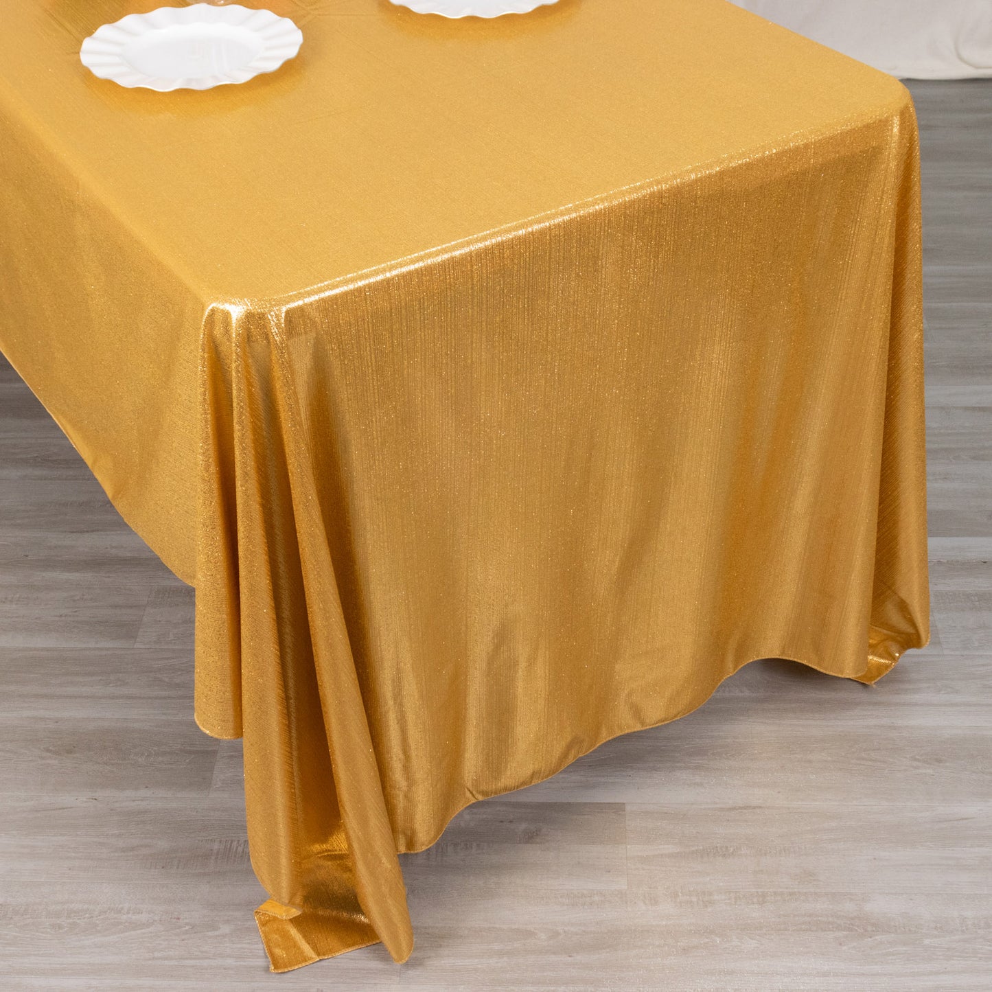 Shiny gold rectangular tablecloth with shimmer sequin dots.