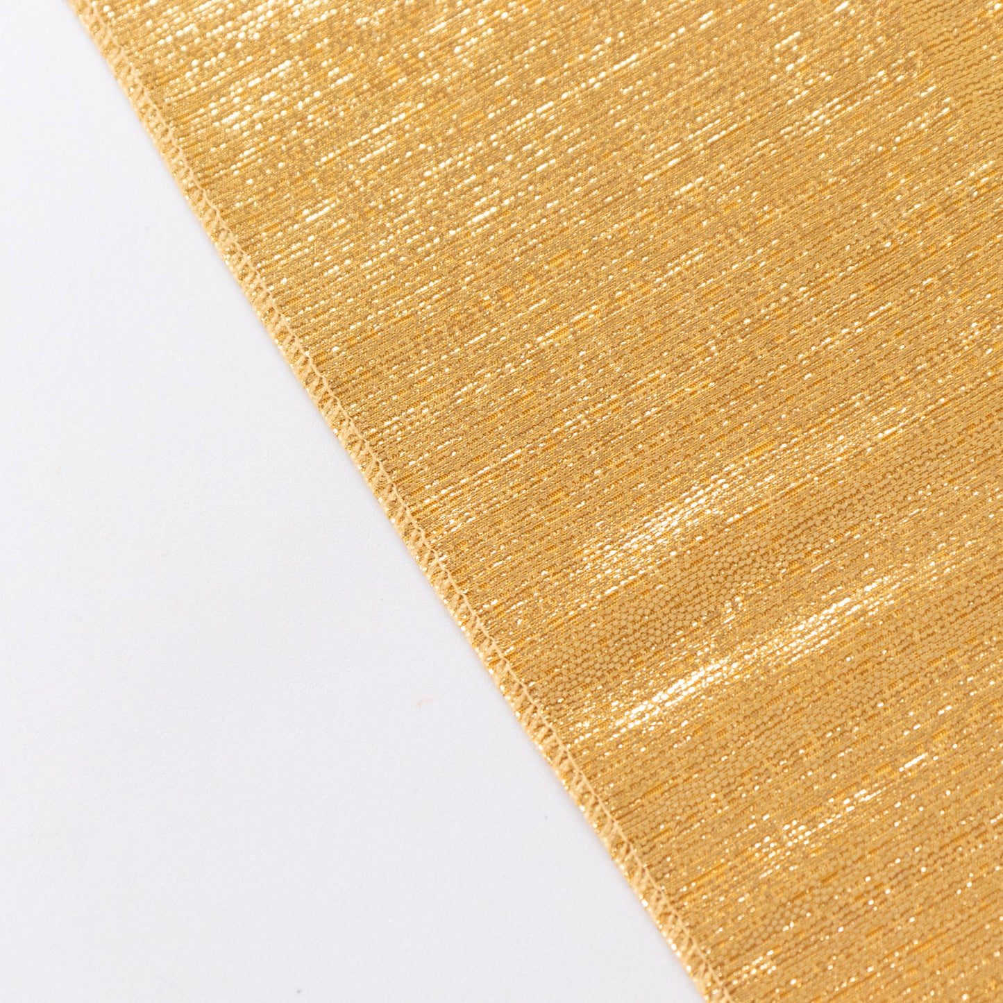 Shiny gold rectangular tablecloth with shimmer sequin dots.