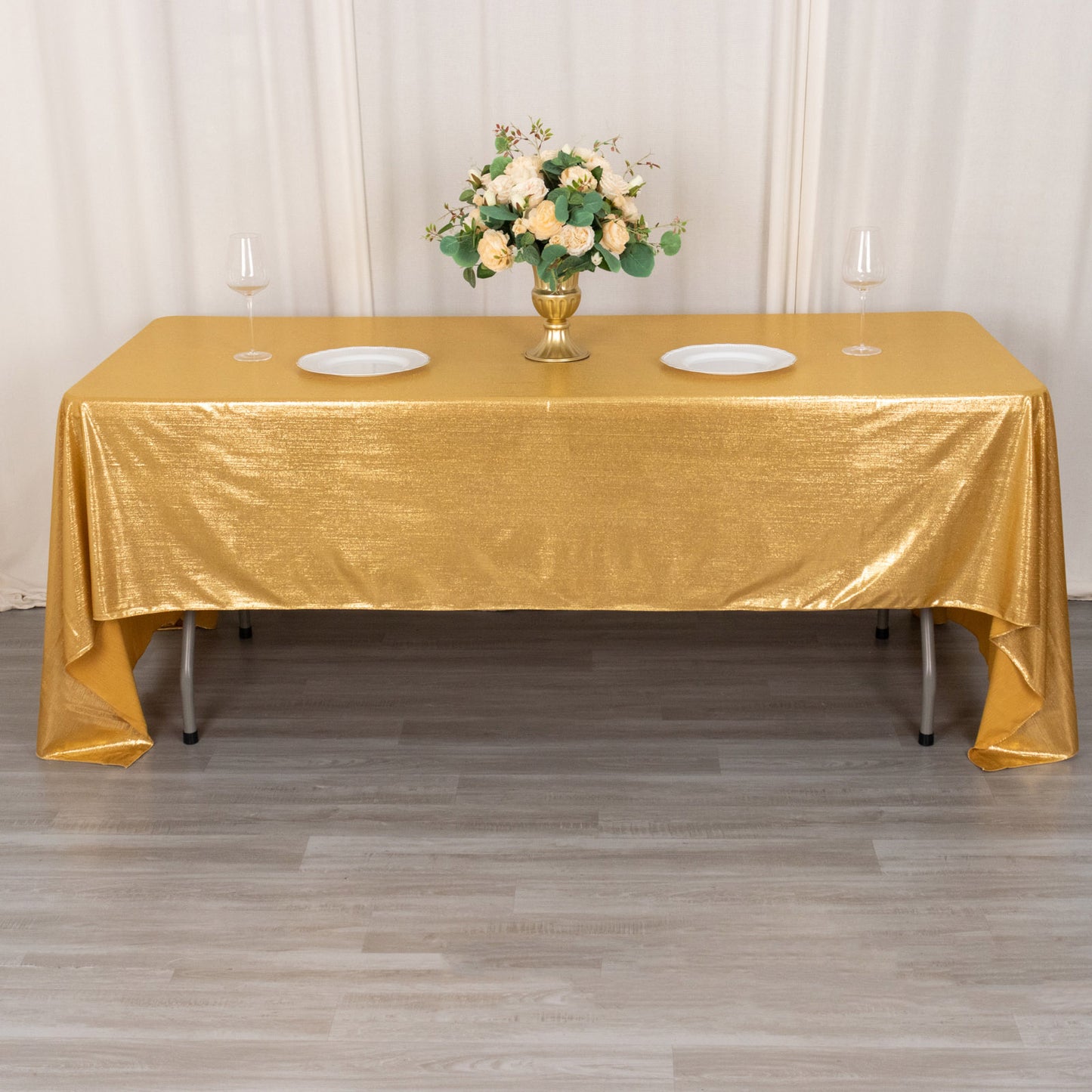 Shiny gold rectangular tablecloth with shimmer sequin dots on a dining table.