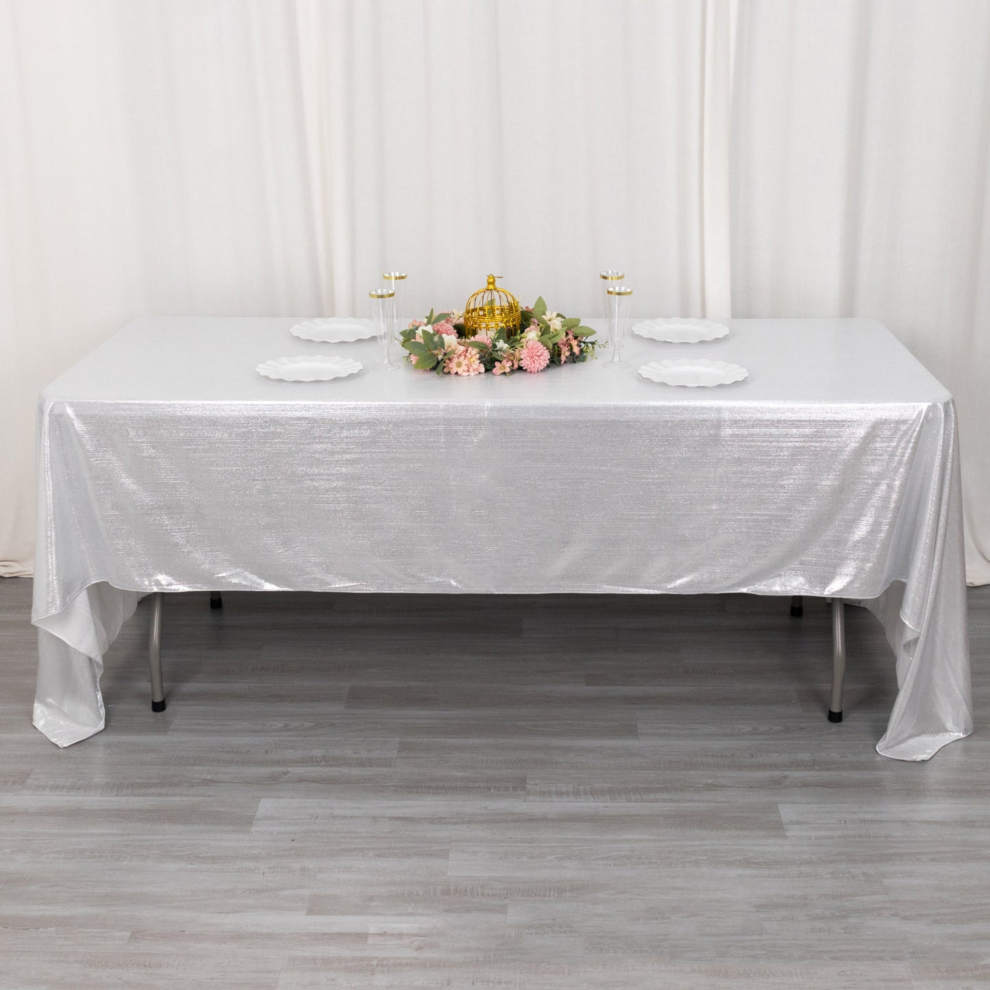 Shiny silver rectangular tablecloth with shimmer sequin dots on a dining table.