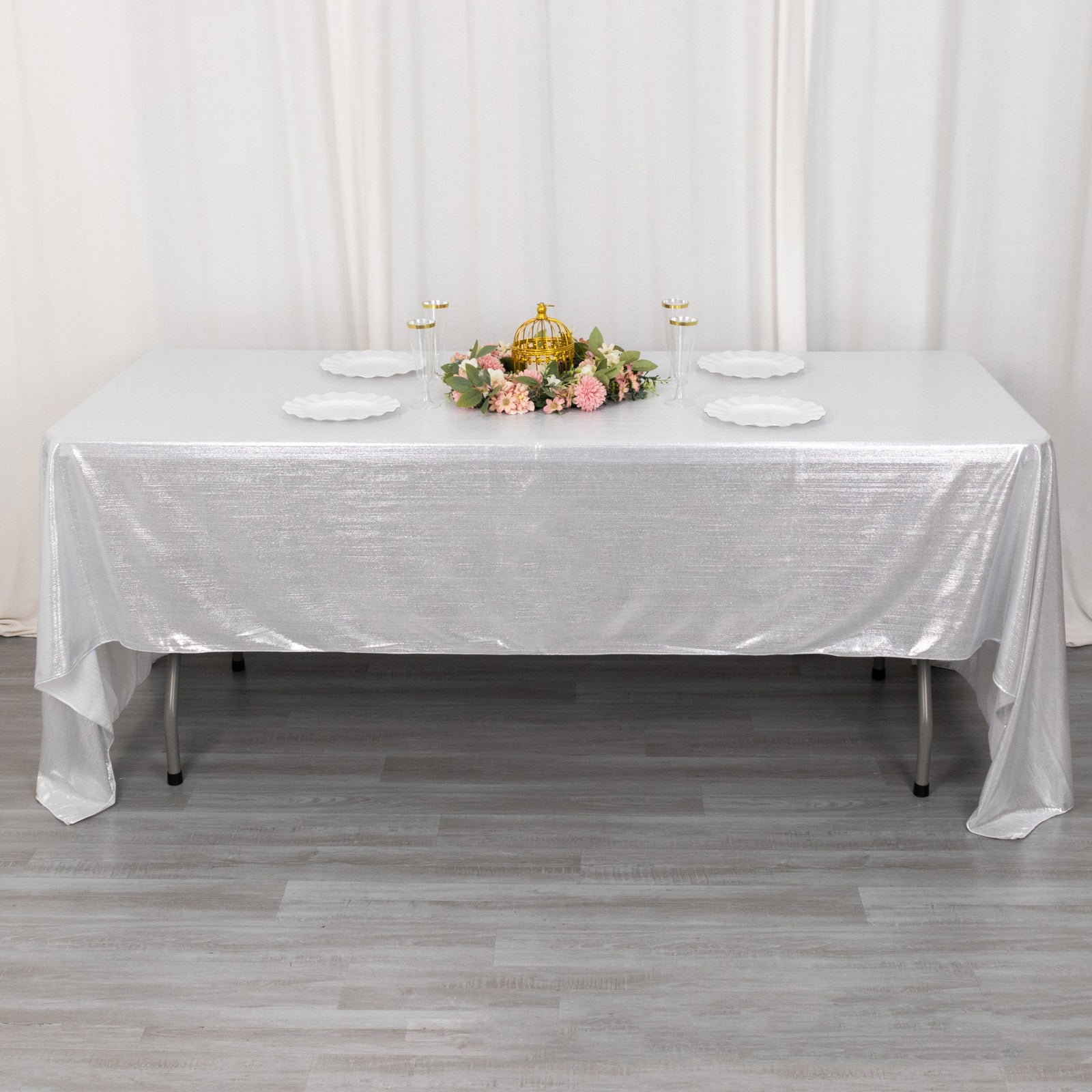Shiny silver rectangular tablecloth with shimmer sequin dots on a dining table.