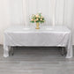 Shiny silver rectangular tablecloth with shimmer sequin dots on a dining table.