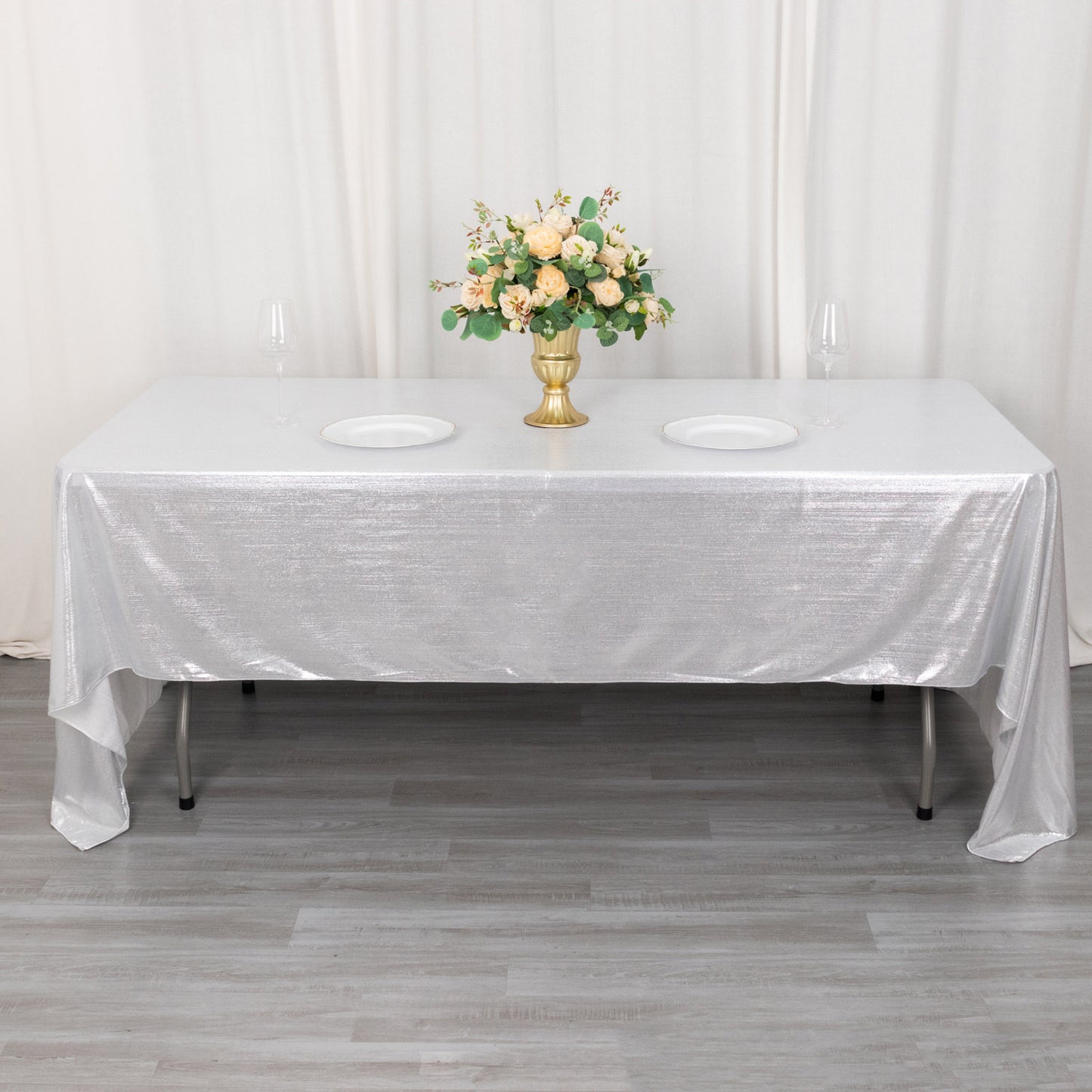 Shiny silver rectangular tablecloth with shimmer sequin dots on a dining table.