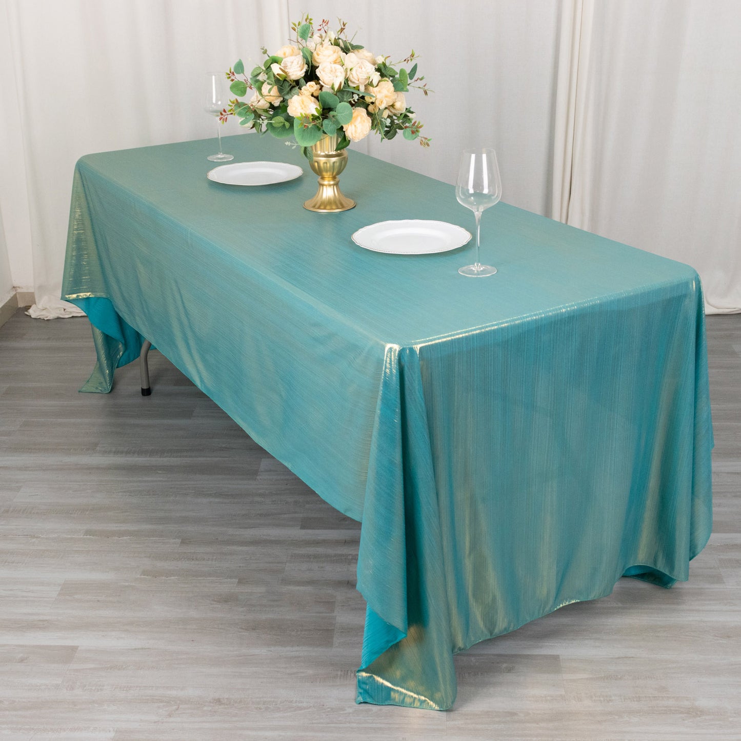 Shiny turquoise tablecloth with shimmer sequin dots on table.