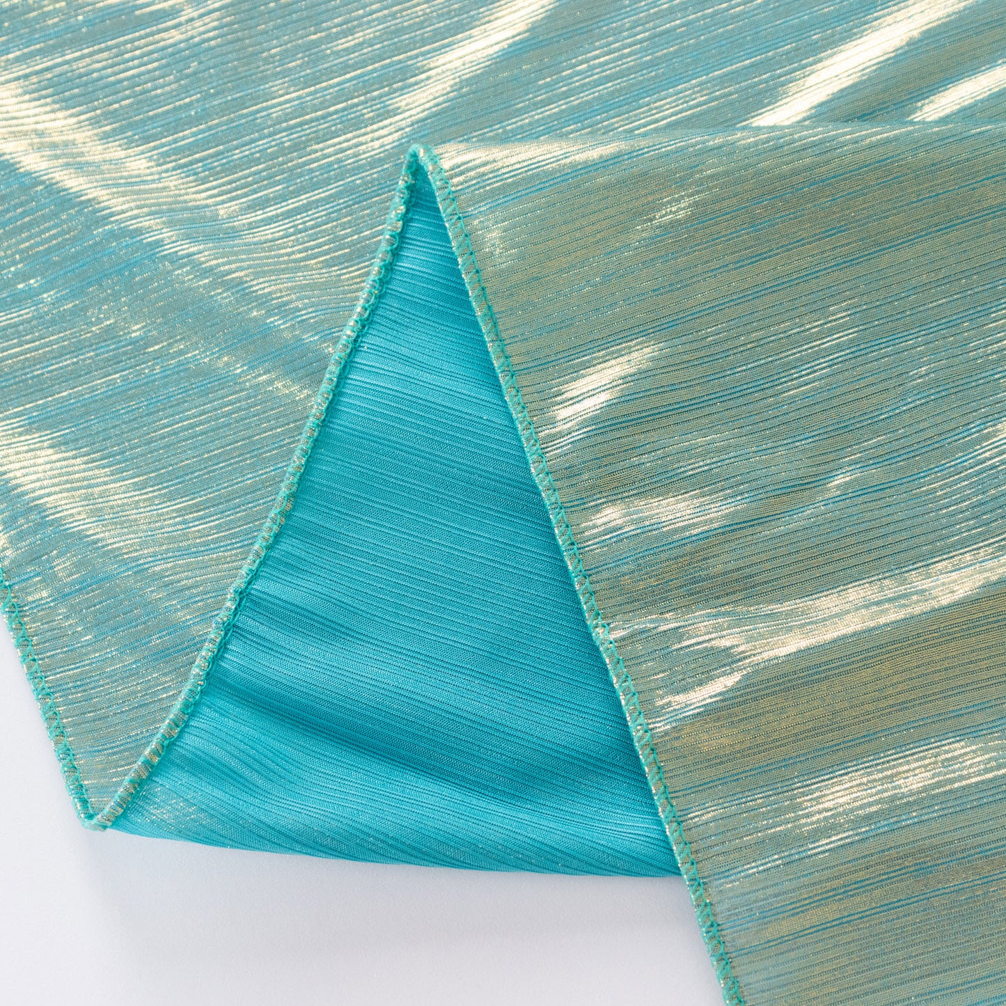 Shiny turquoise polyester tablecloth with shimmer sequin dots.