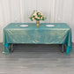 Shiny turquoise tablecloth with shimmer sequin dots on a dining table.