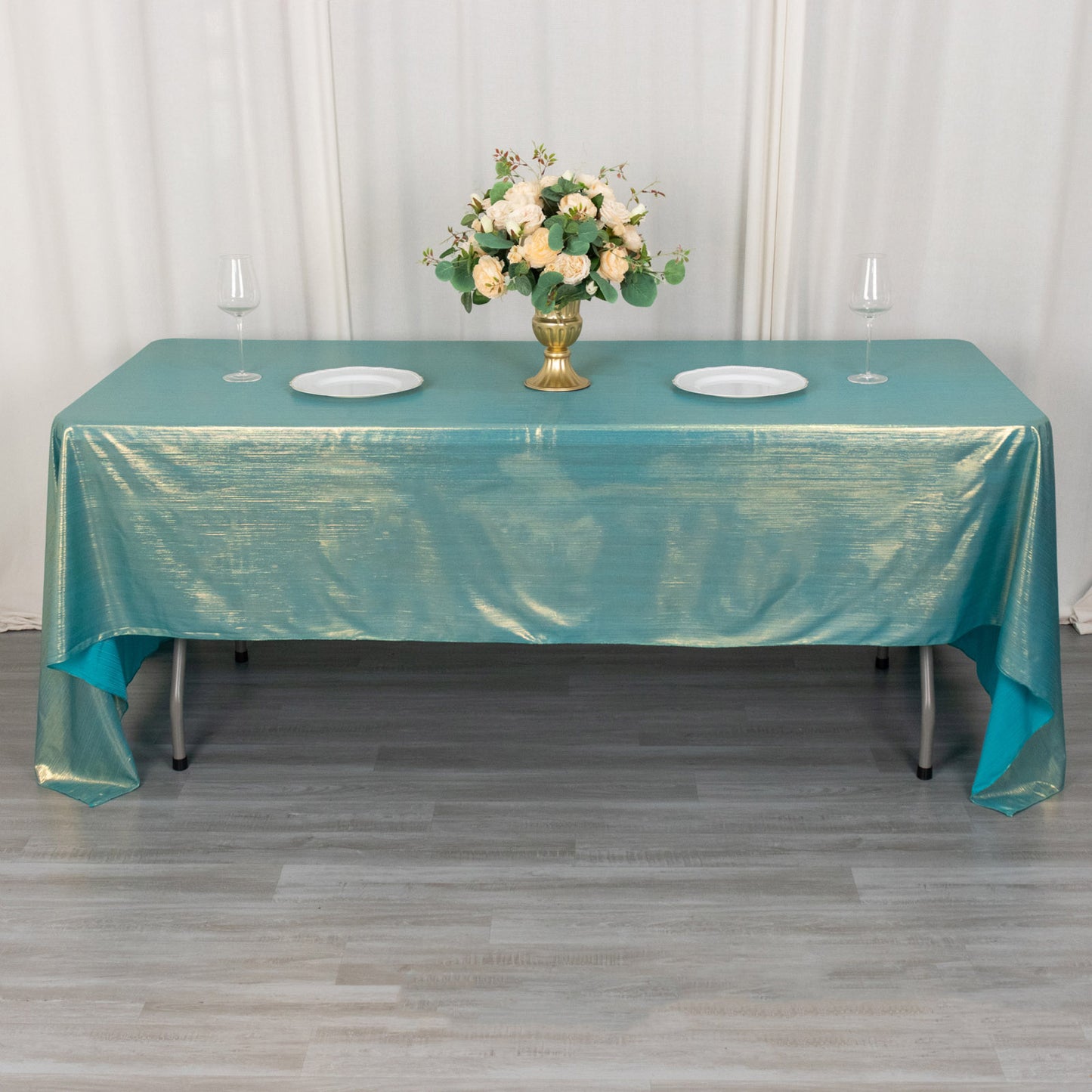 Shiny turquoise tablecloth with shimmer sequin dots on a dining table.