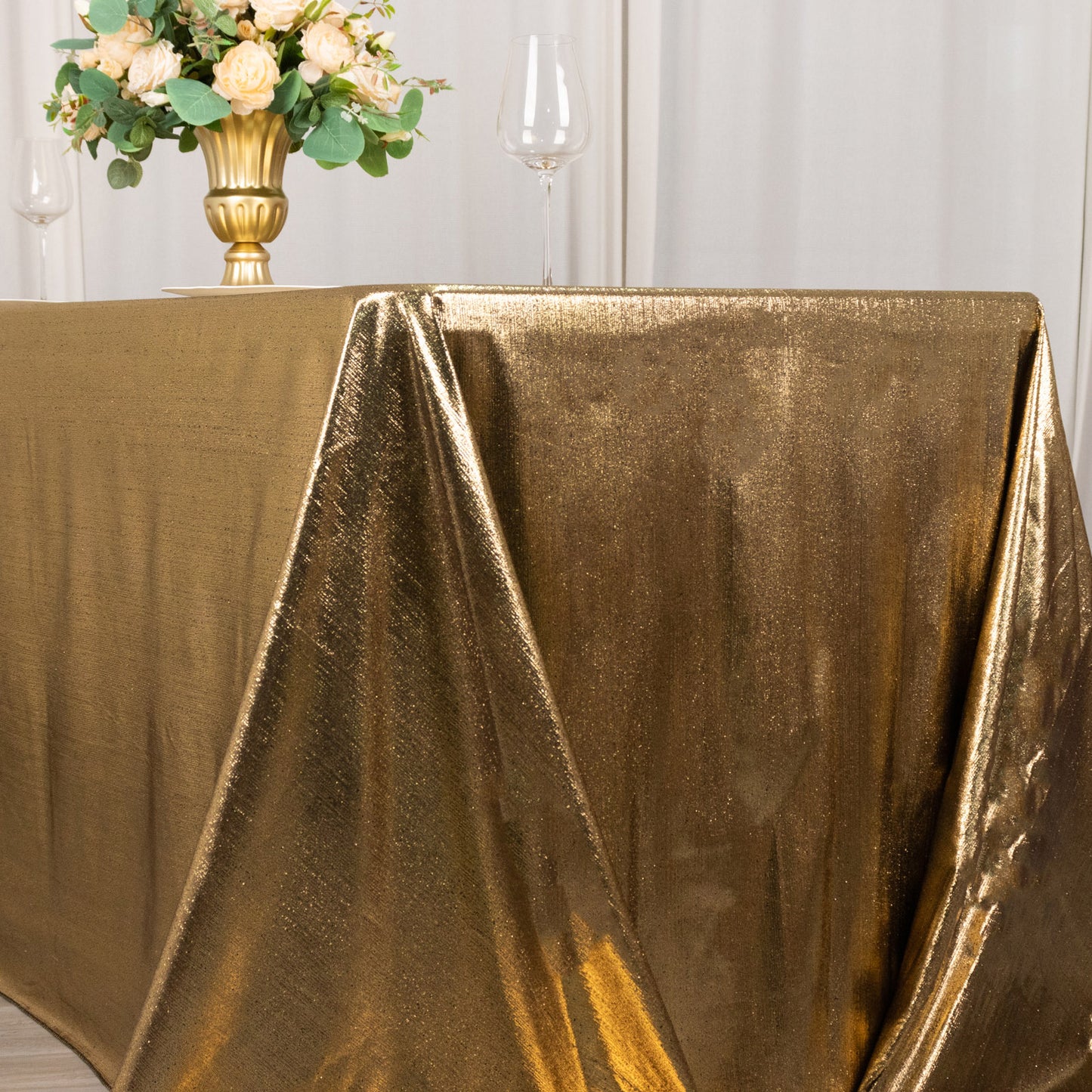 Antique gold shimmer sequin tablecloth with a sparkling glitter finish.