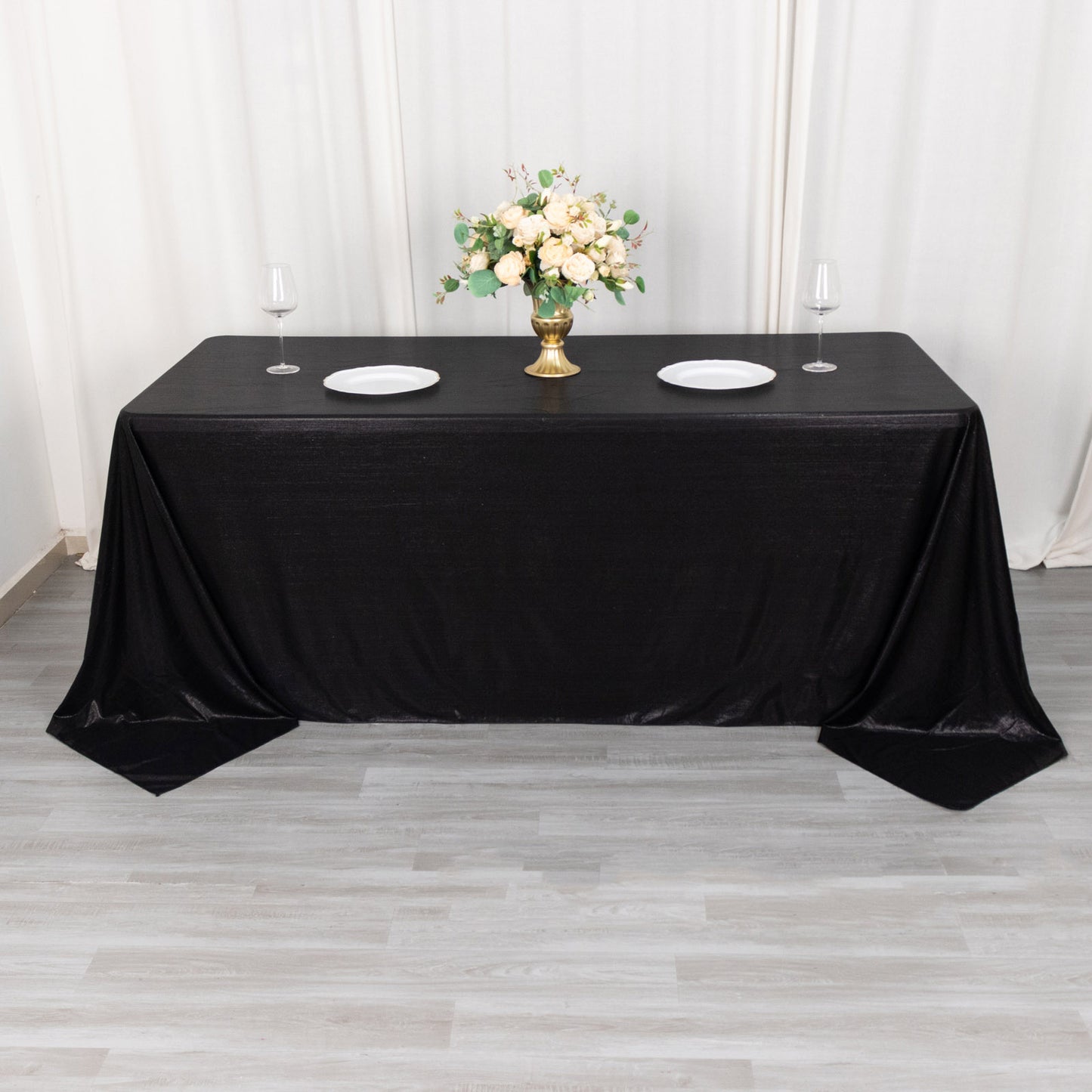 Black shimmer sequin dots tablecloth on a dining table.