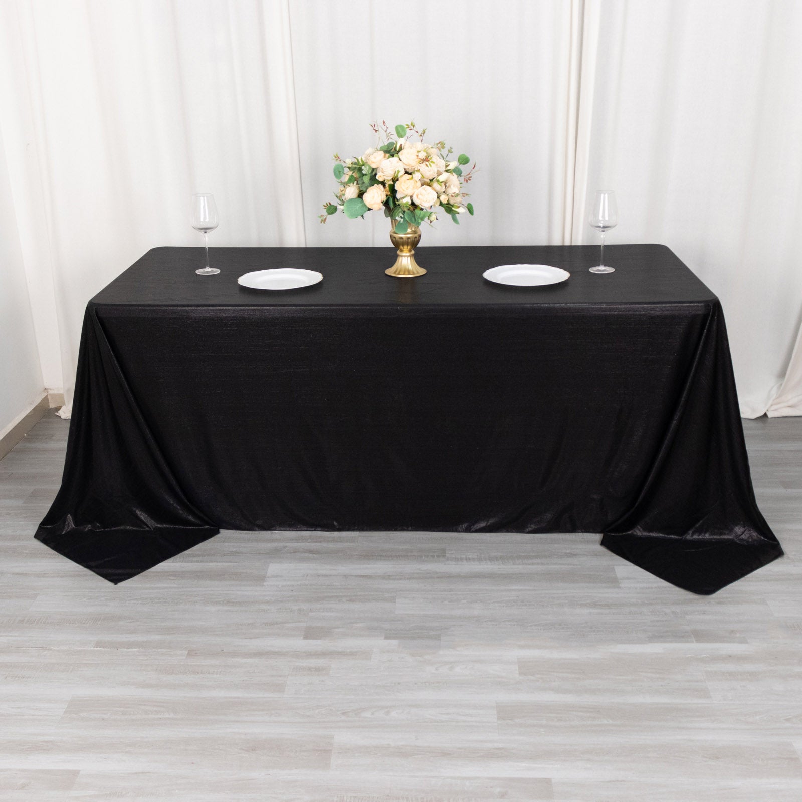 Black shimmer sequin dots tablecloth on a dining table.