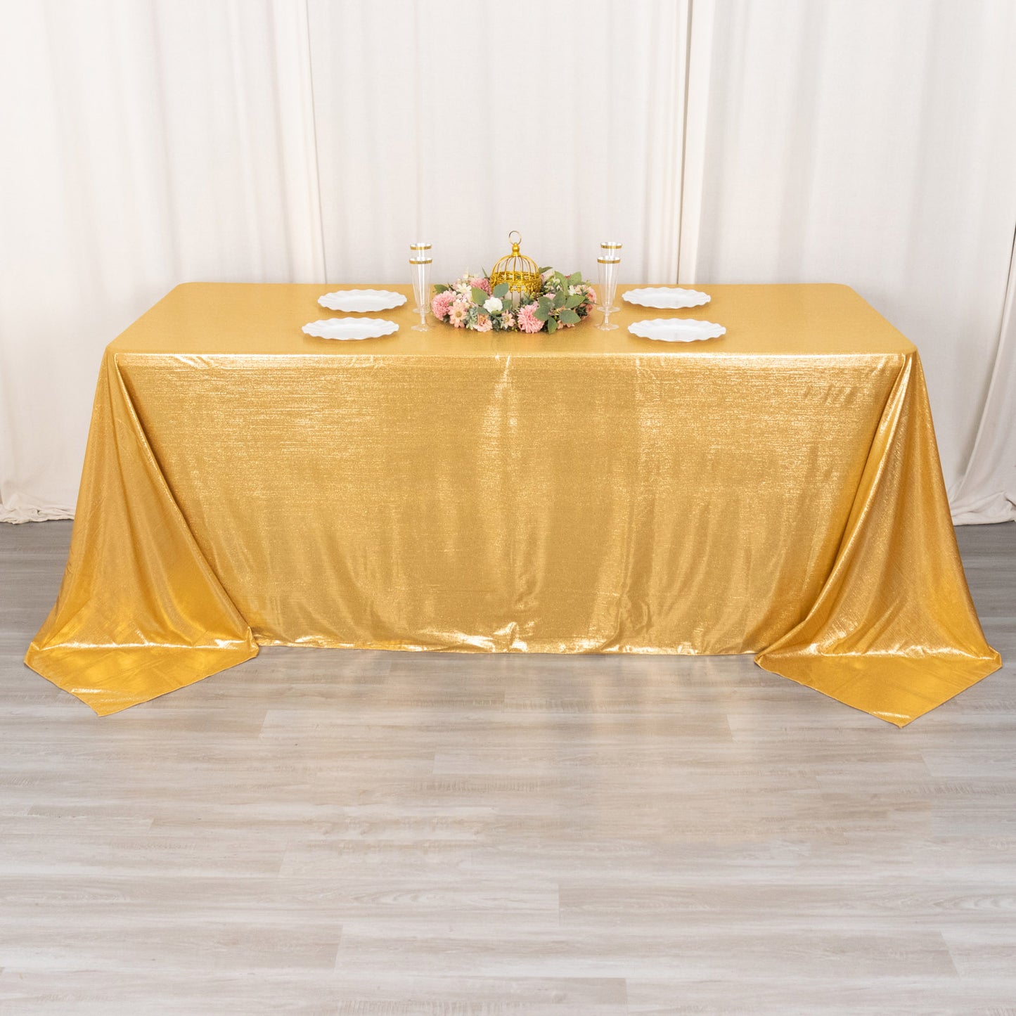 Gold shimmer sequin dots polyester tablecloth on a decorated table.