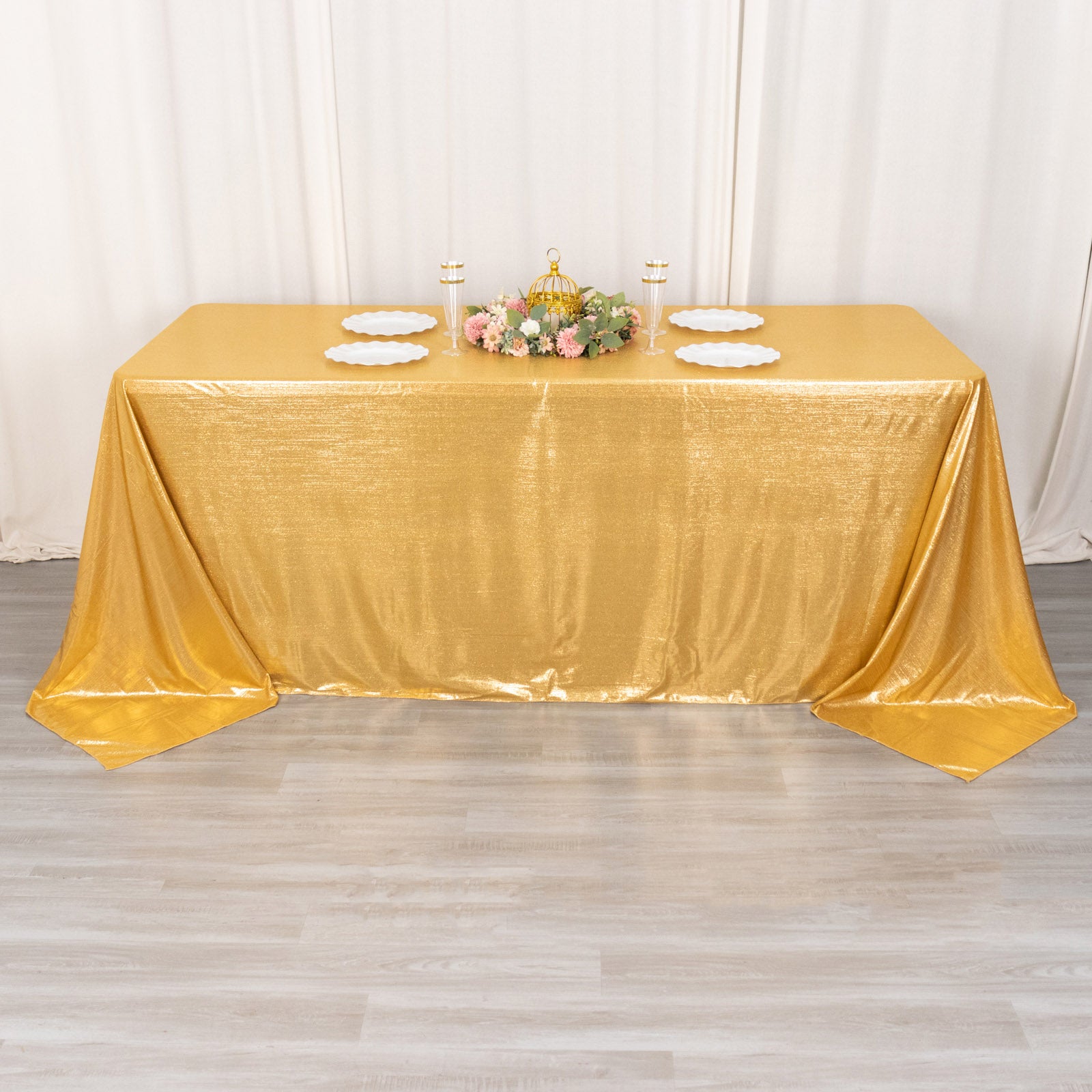 Gold shimmer sequin dots polyester tablecloth on a decorated table.