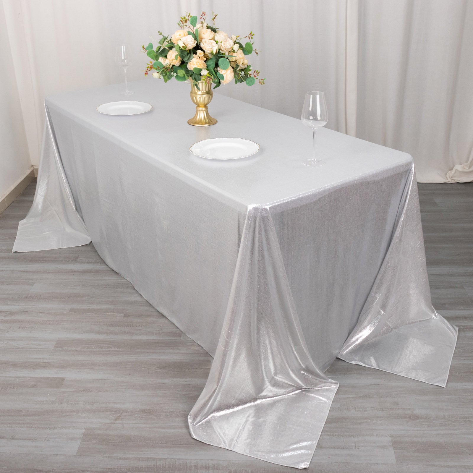 Silver shimmer sequin tablecloth with a glittery finish on a dining table.