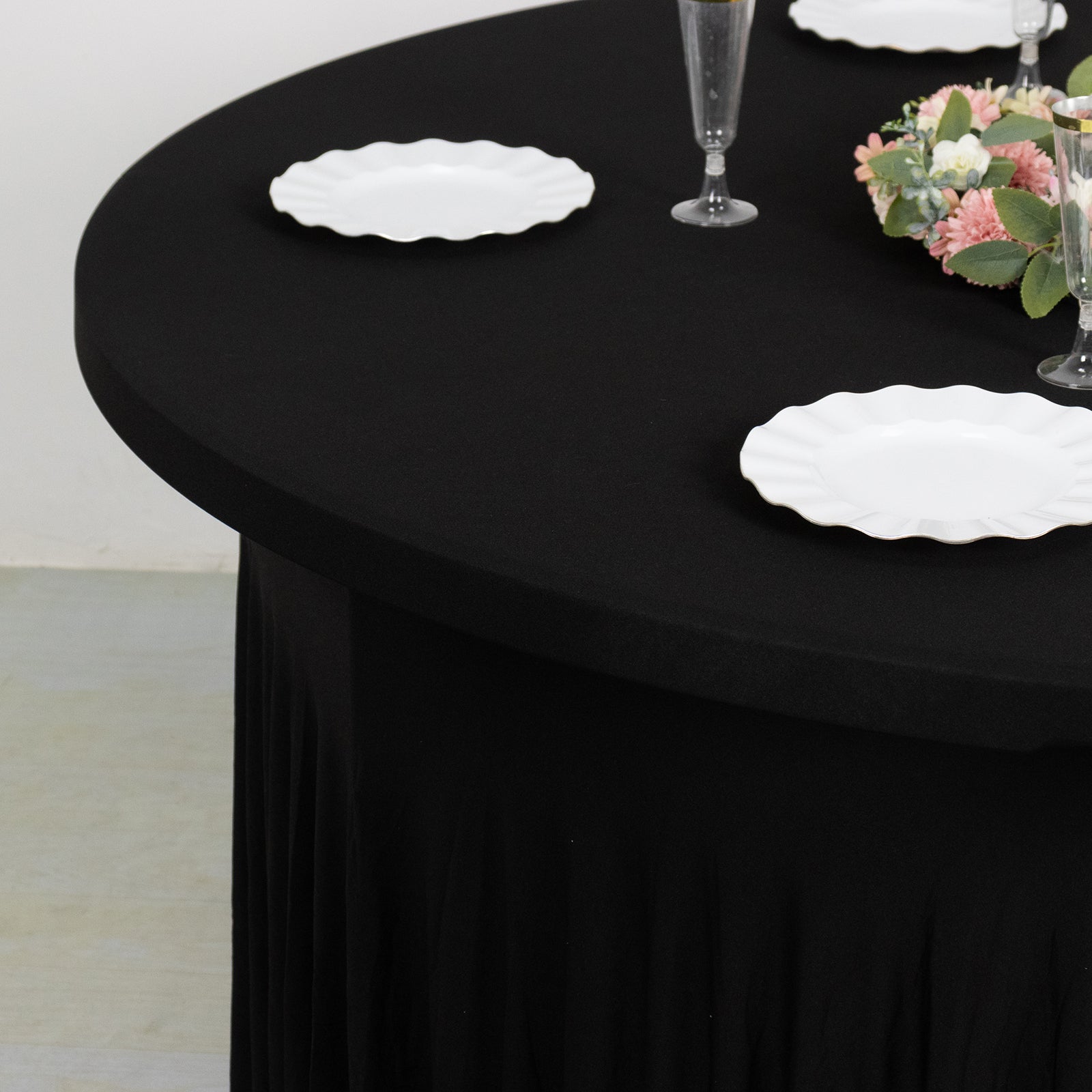 Black wavy spandex fitted tablecloth for 72-inch tables with ruffles.