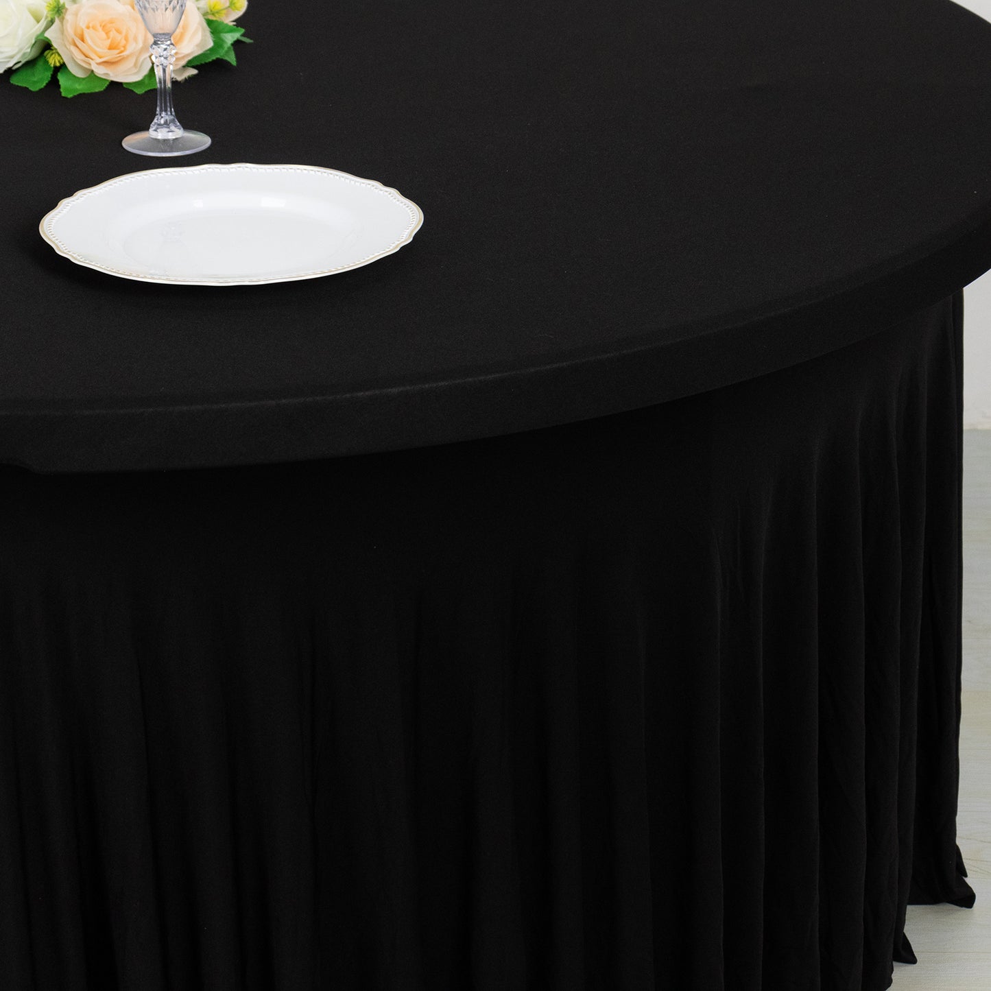 Black wavy spandex fitted tablecloth for 72-inch tables with ruffles.