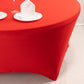 Red round spandex tablecloth fitted for 72 inch tables.