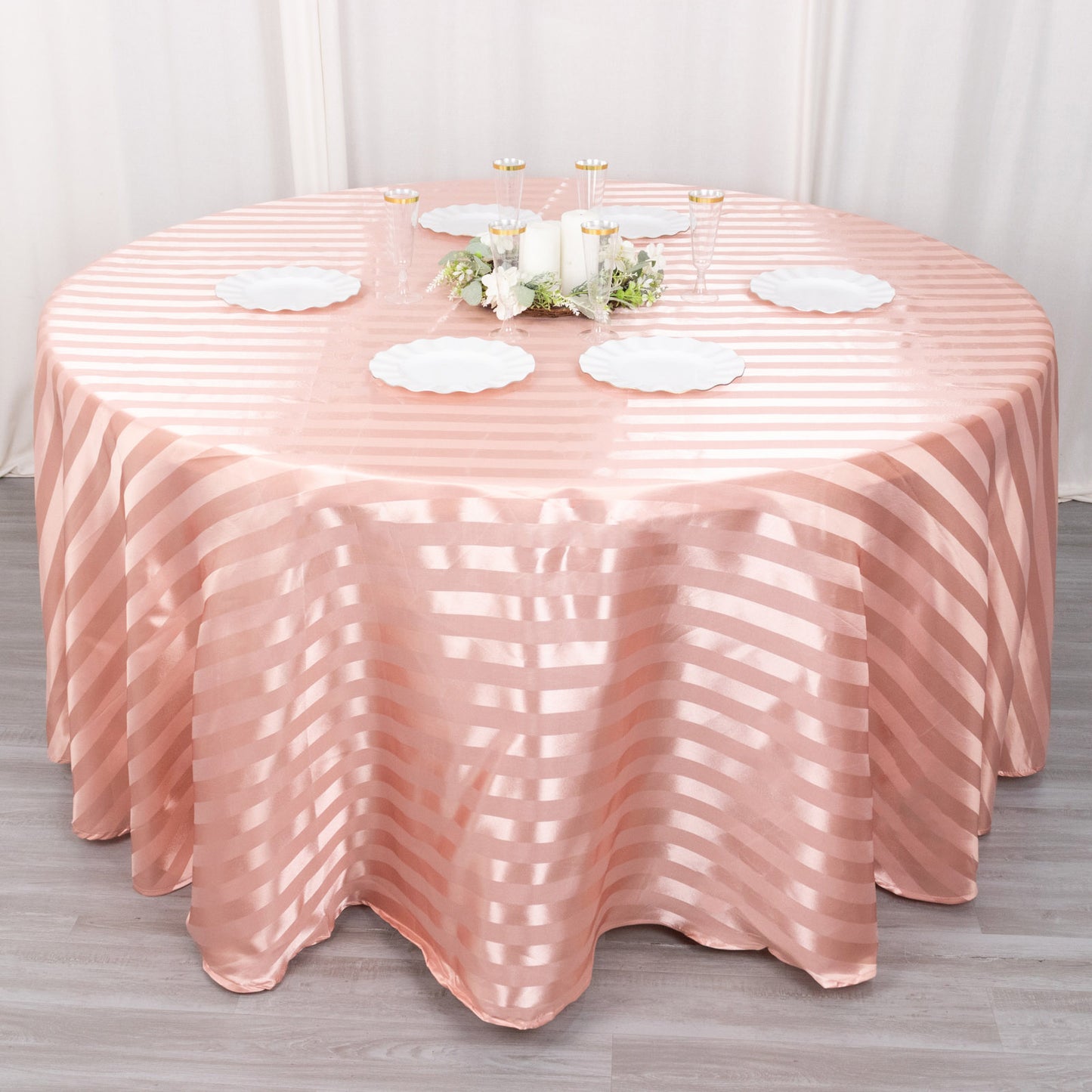 120" Dusty Rose Satin Stripe Round Tablecloth on a round table.