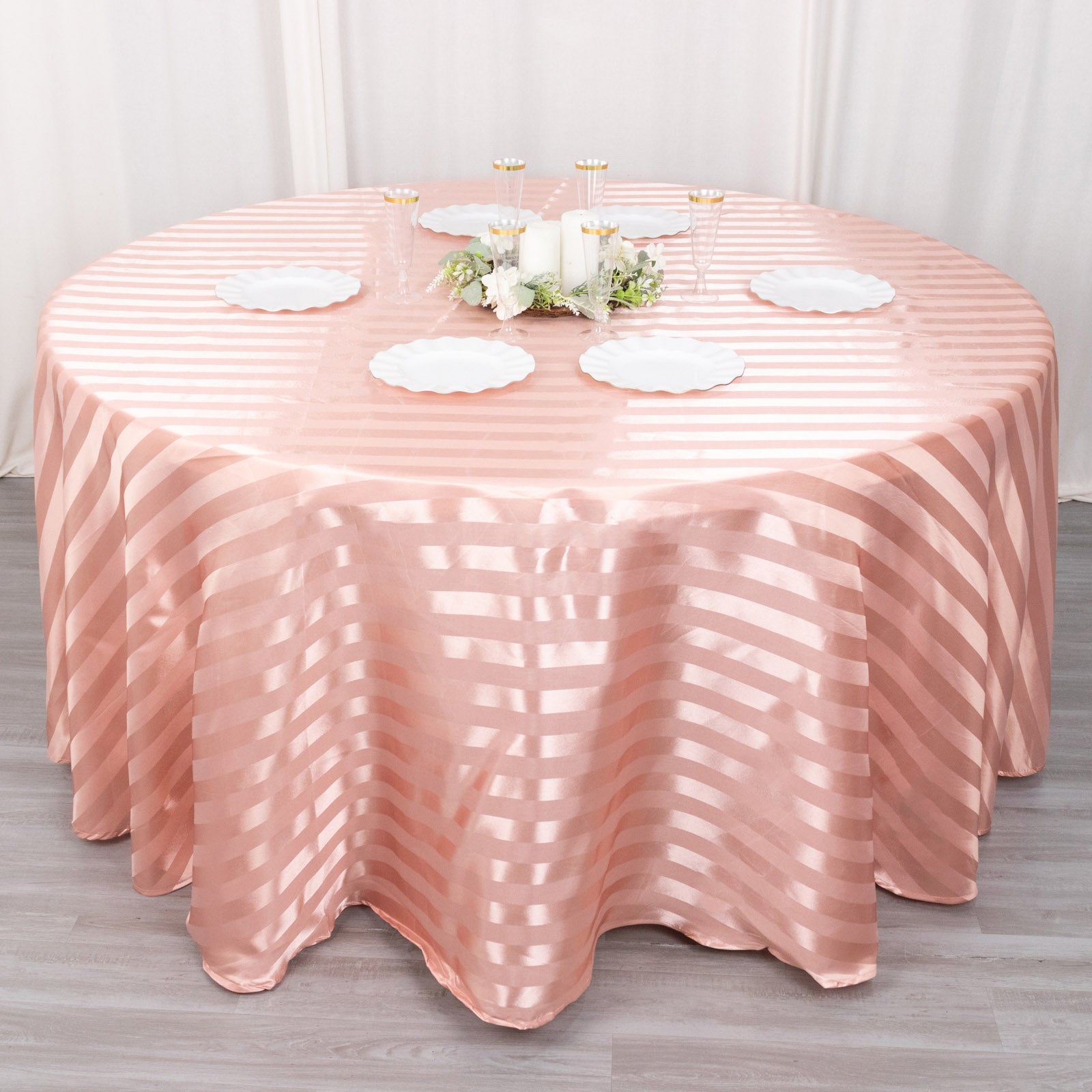 120" Dusty Rose Satin Stripe Round Tablecloth on a round table.