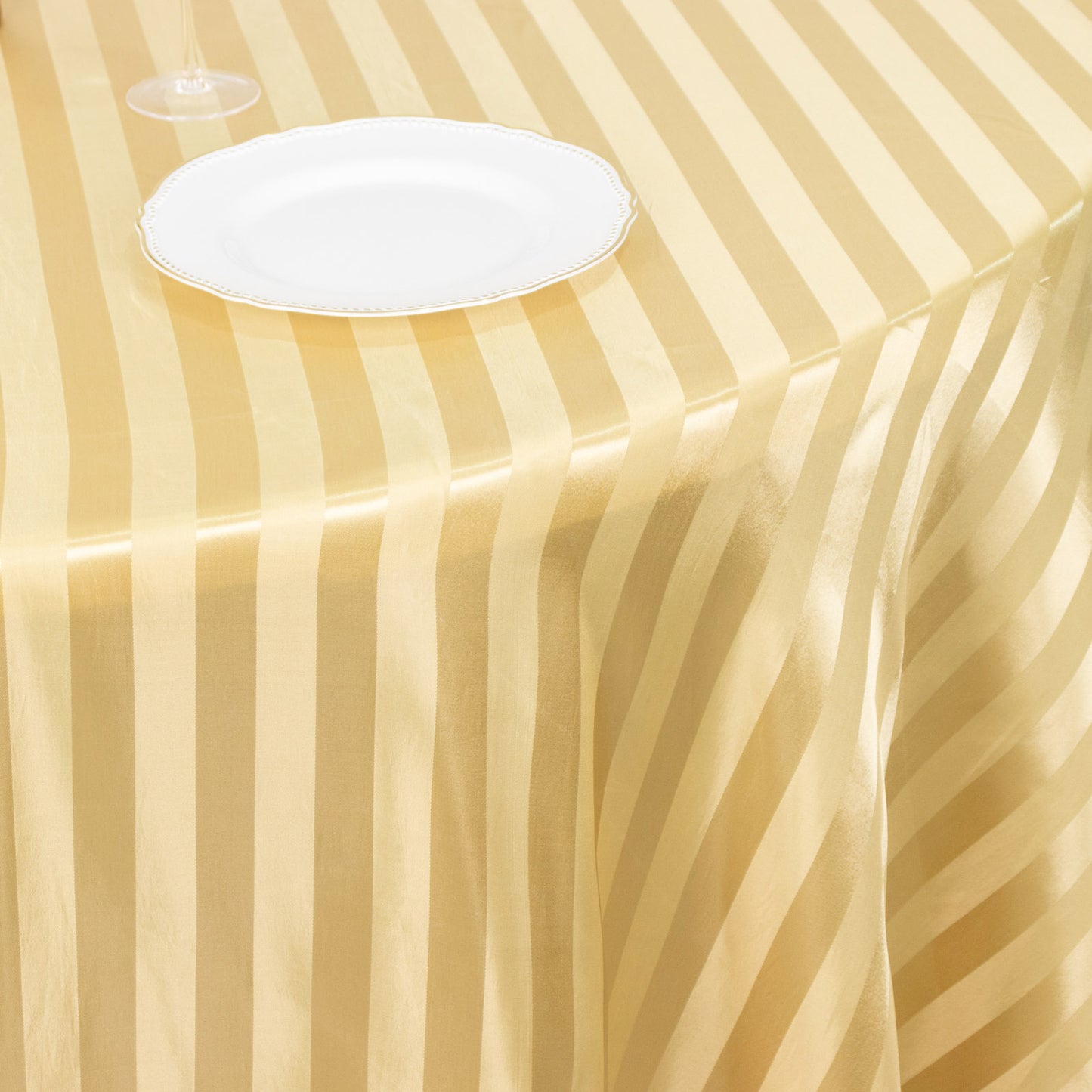 Champagne satin stripe seamless round tablecloth on a table.
