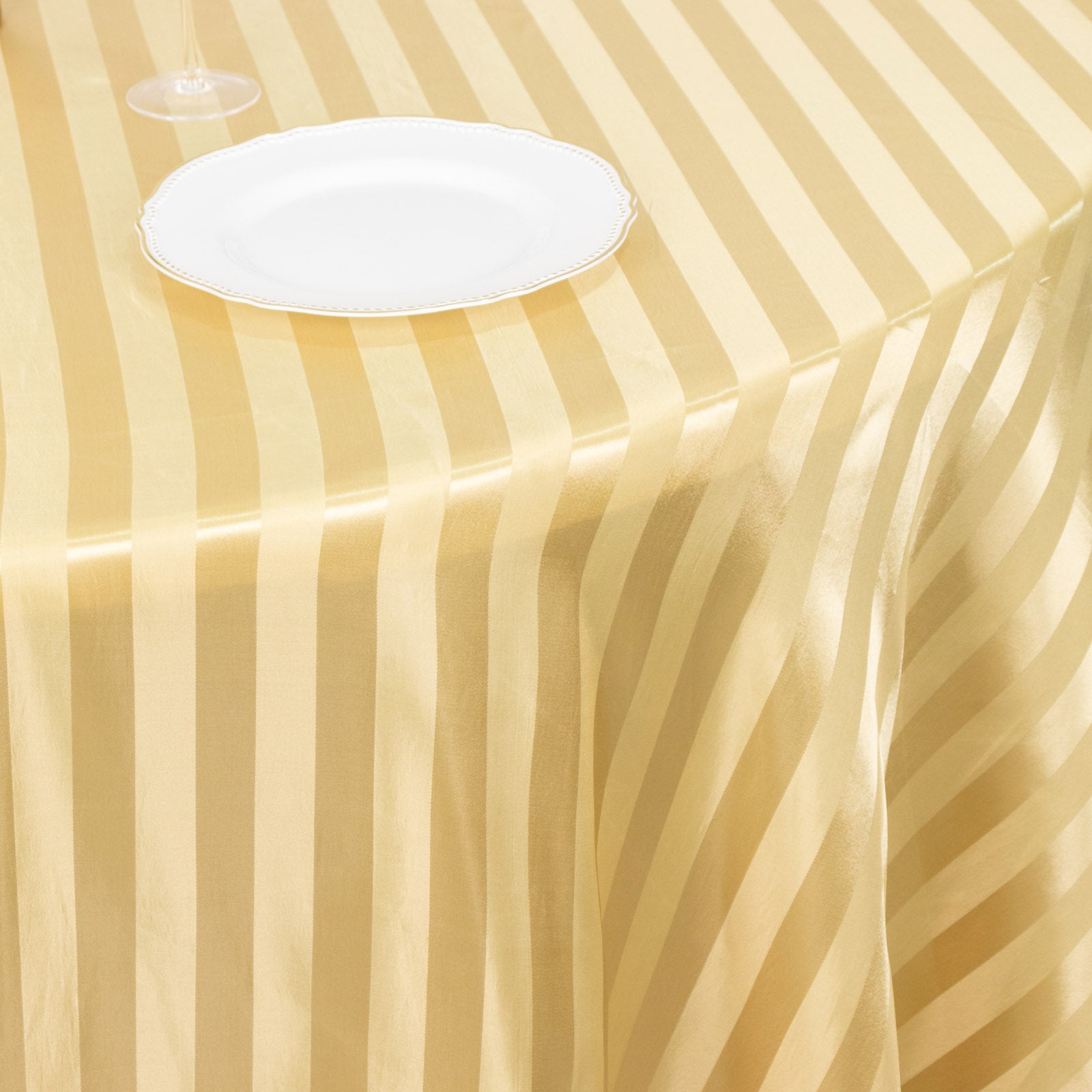 Champagne satin stripe seamless round tablecloth on a table.
