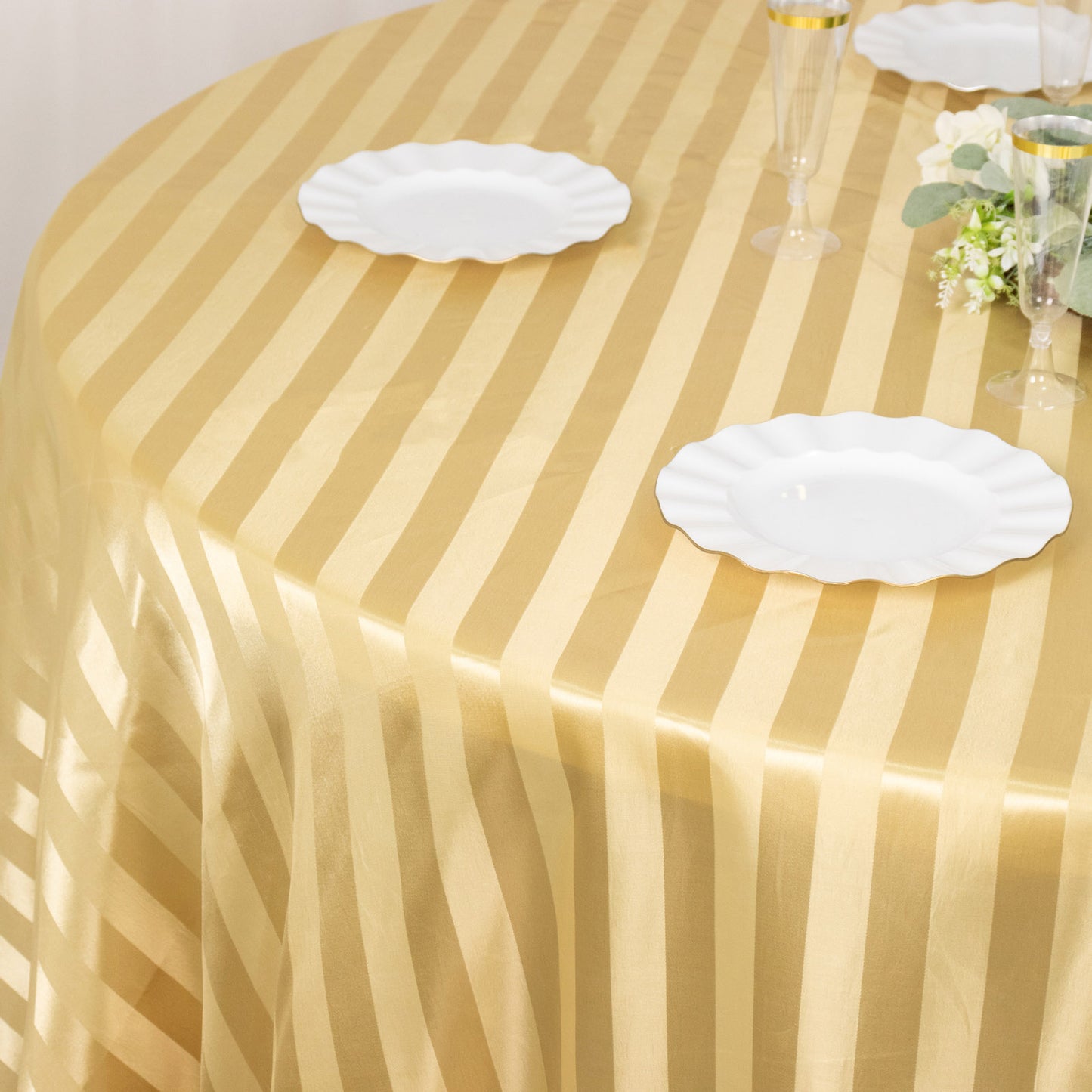 Champagne satin stripe seamless round tablecloth on a table.