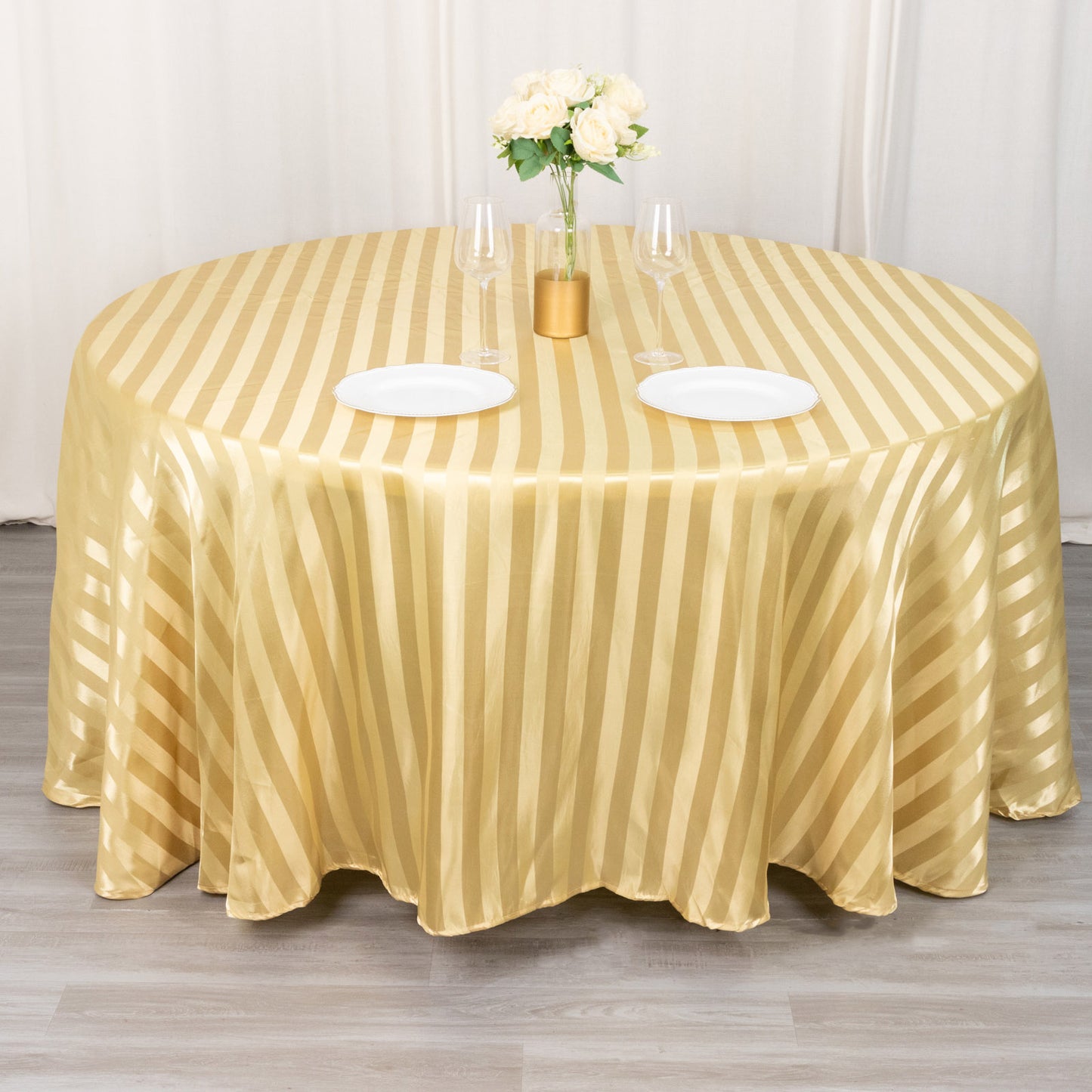 Champagne satin stripe seamless round tablecloth on a dining table.