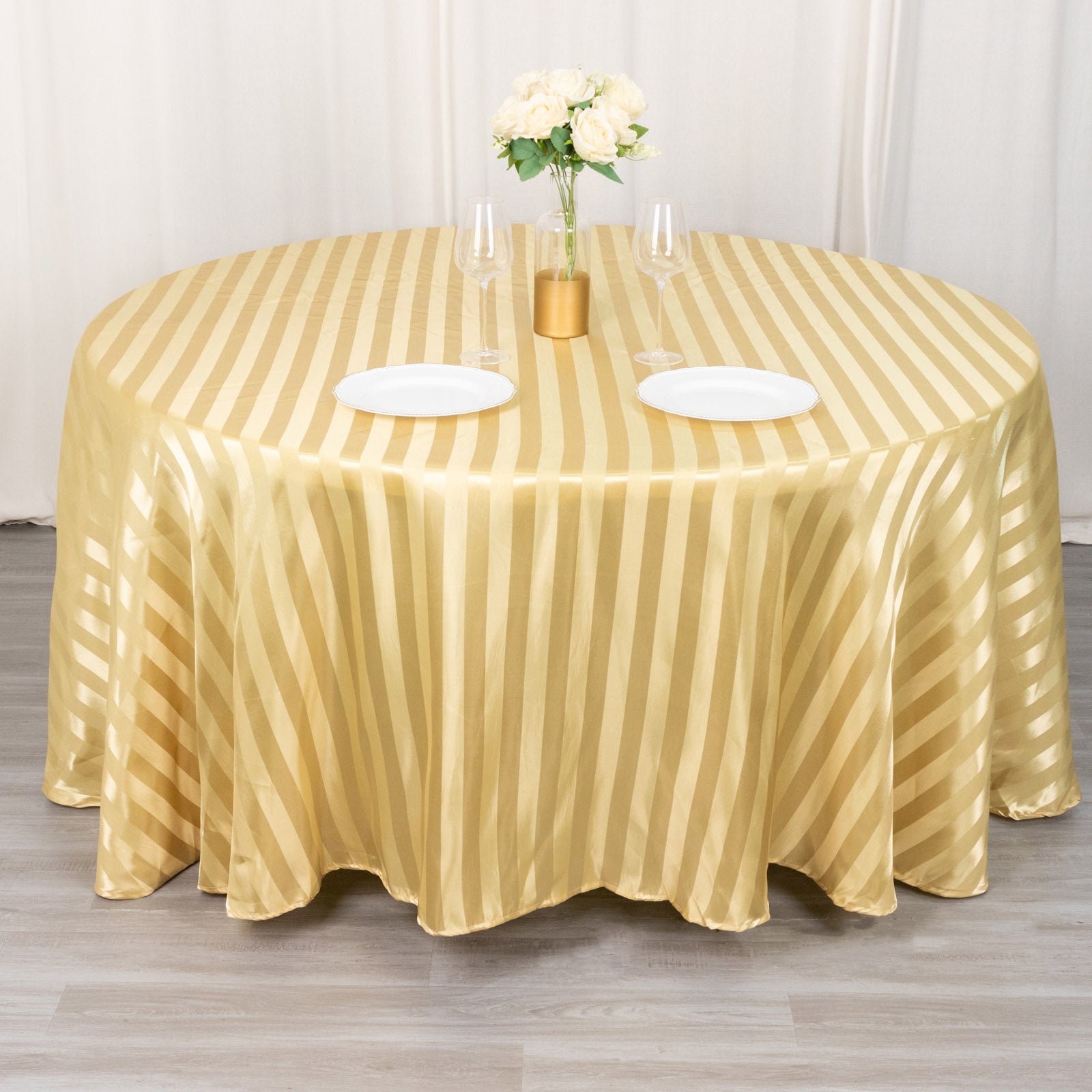 Champagne satin stripe seamless round tablecloth on a dining table.