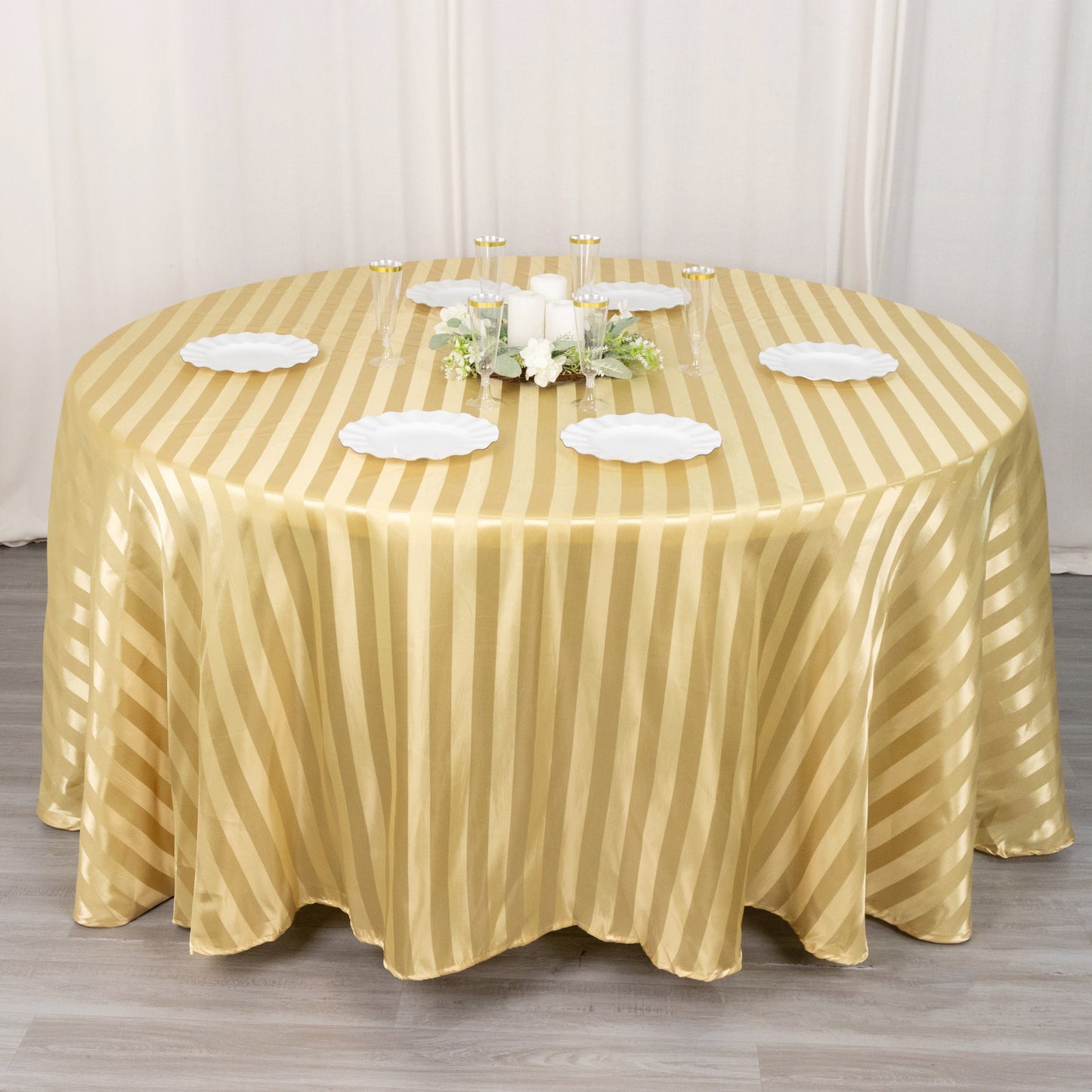 Champagne satin stripe round tablecloth on a dining table.